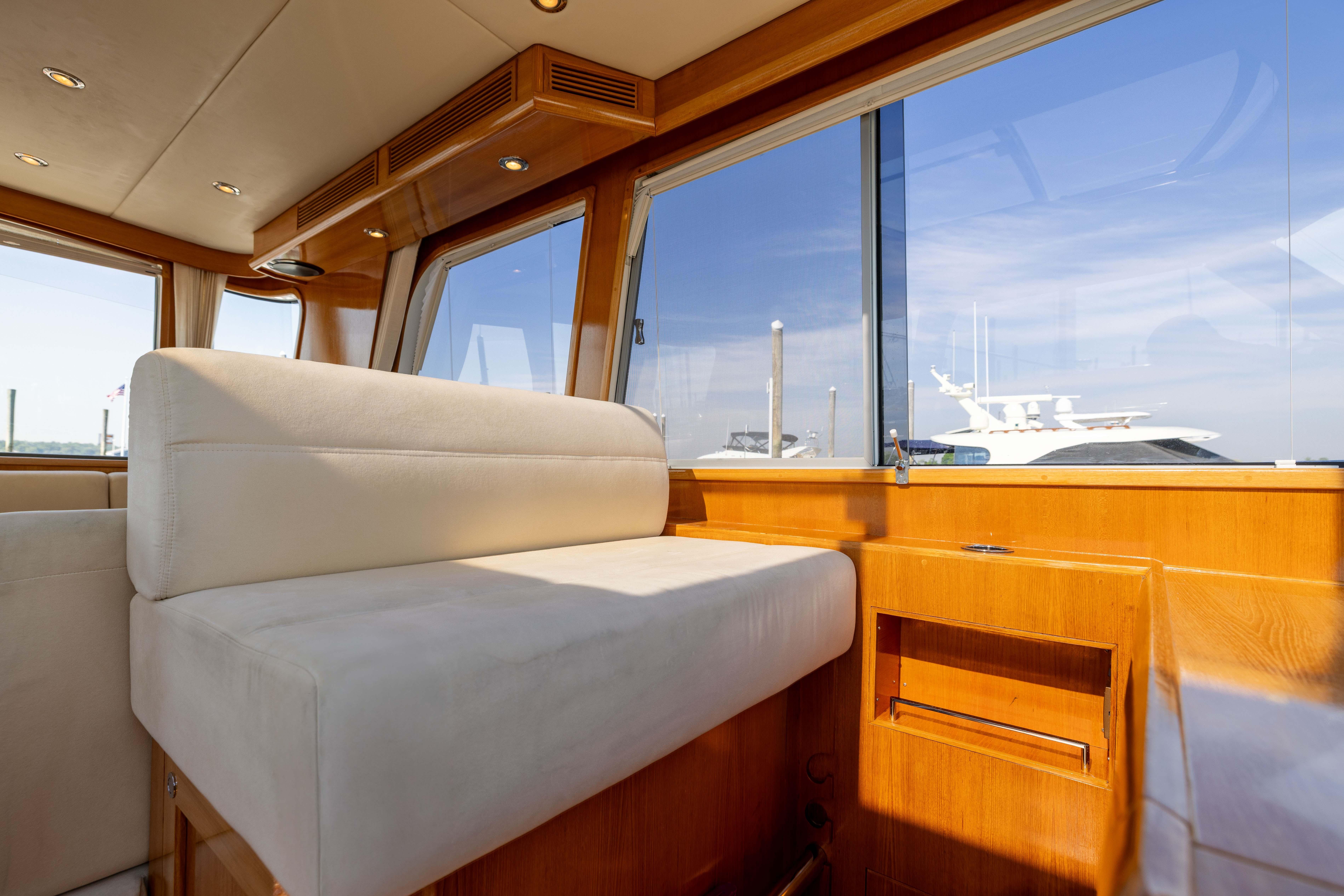 Interior of 2008 Grand Banks 45 Eastbay SX yacht with plush seating and large windows.