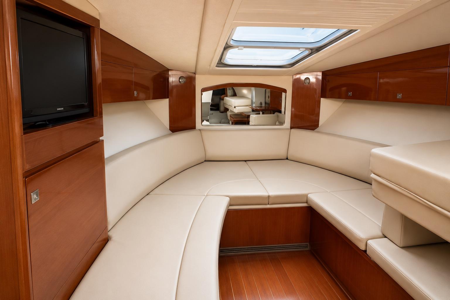 Luxurious interior of 2012 Sea Ray Sundancer 310 yacht with plush seating and wood finishes.