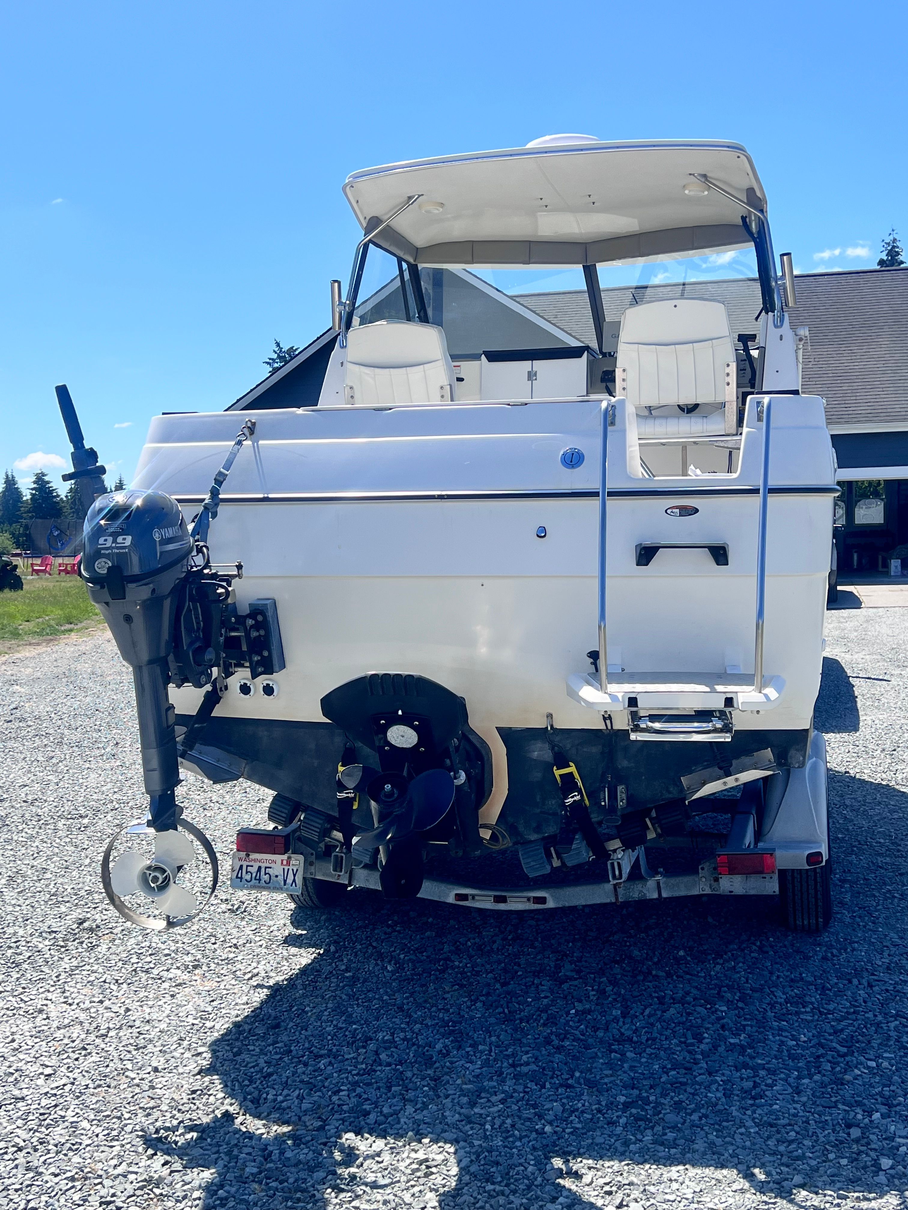 Rear view of a 1997 Bayliner 2452 boat on a trailer.