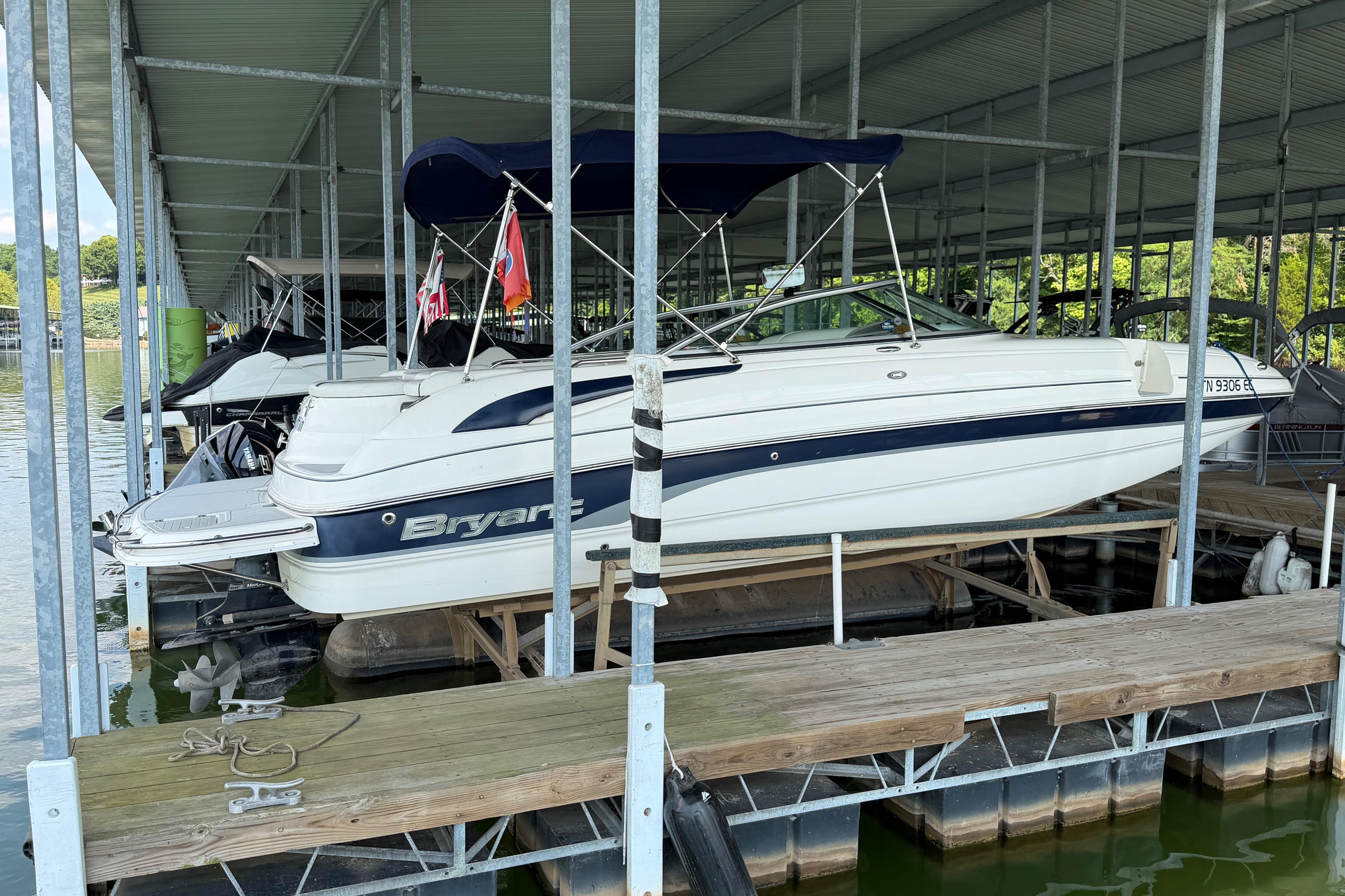 2010 Bryant 255 boat docked under covered marina.