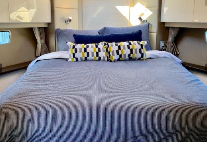 Luxurious bedroom interior of 2016 Carver C37 yacht with stylish bedding and decor.