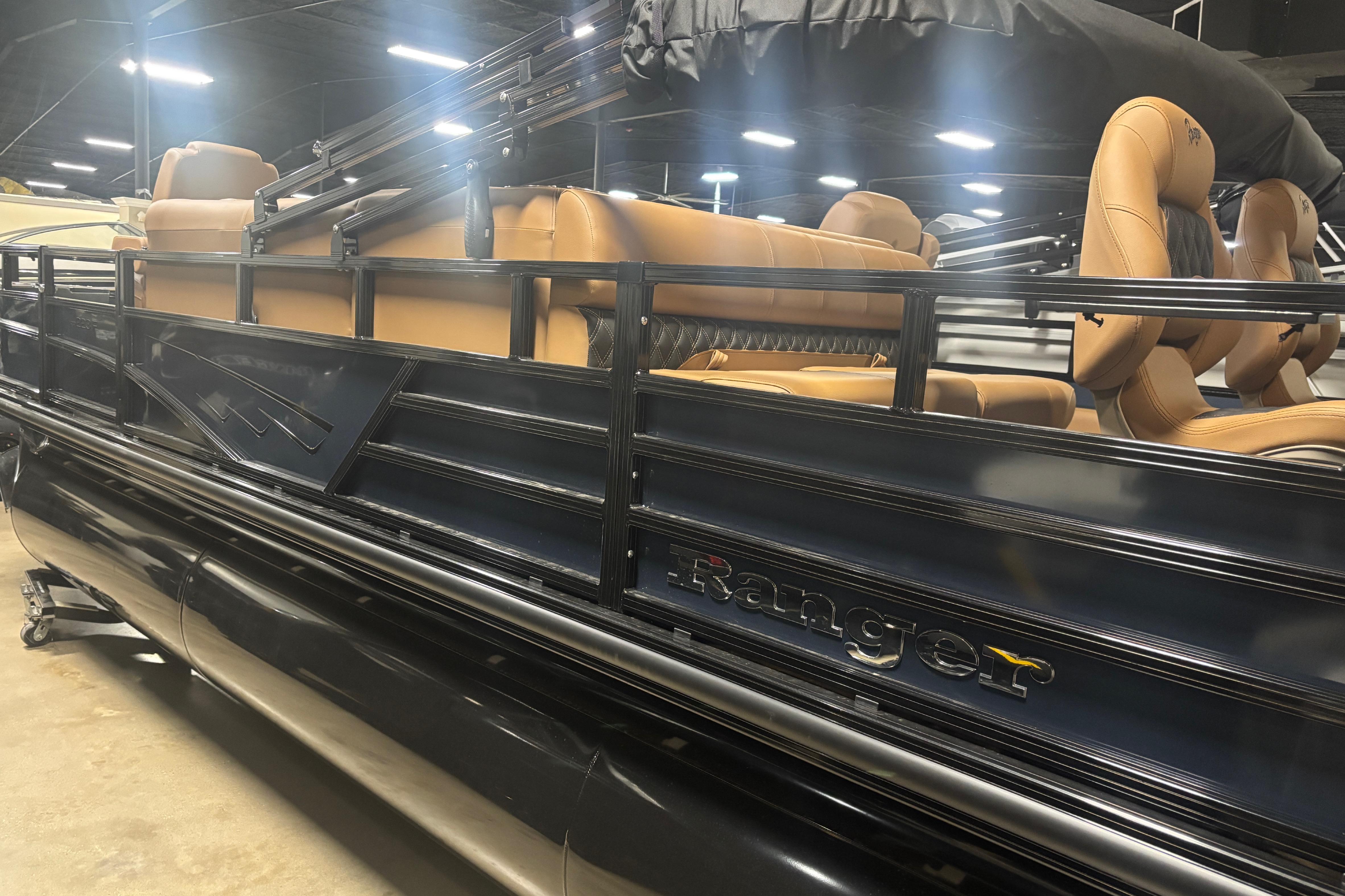 2026 Ranger 223F pontoon boat with tan seating and sleek black exterior.