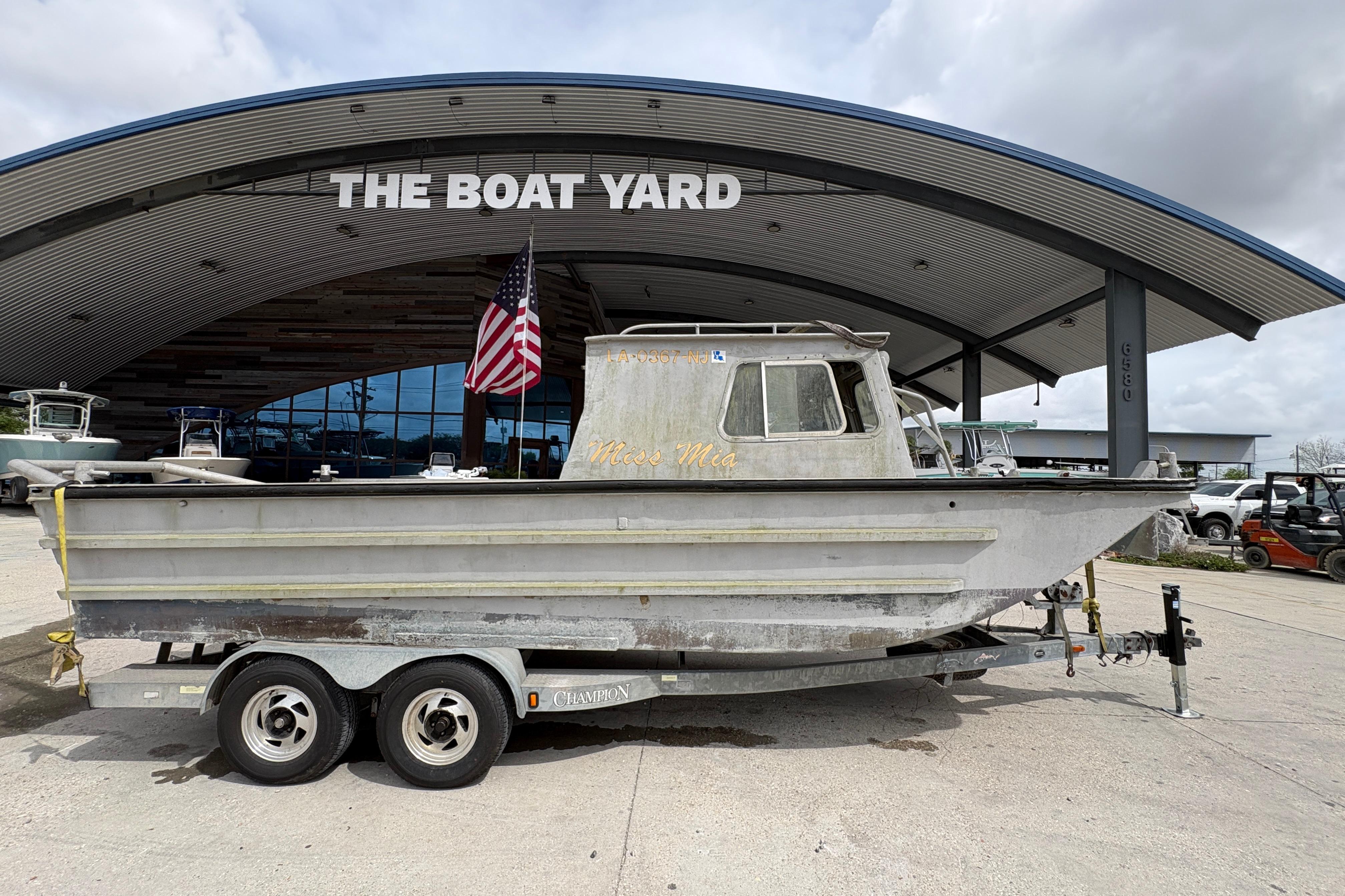 Custom 1972 23' work/push boat on trailer at The Boat Yard.