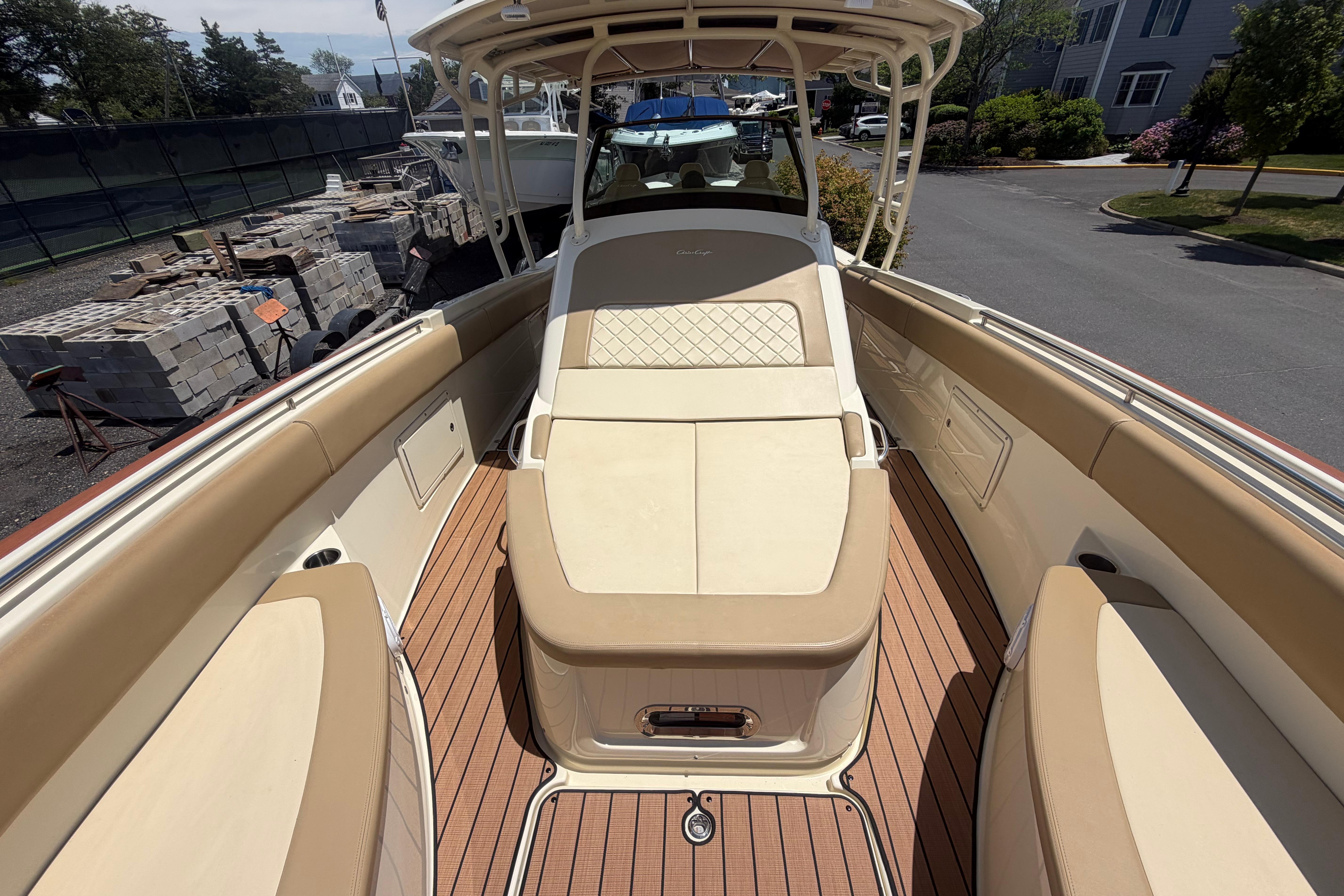 2017 Chris-Craft Catalina 34 boat with tan seating and teak flooring, docked outdoors.