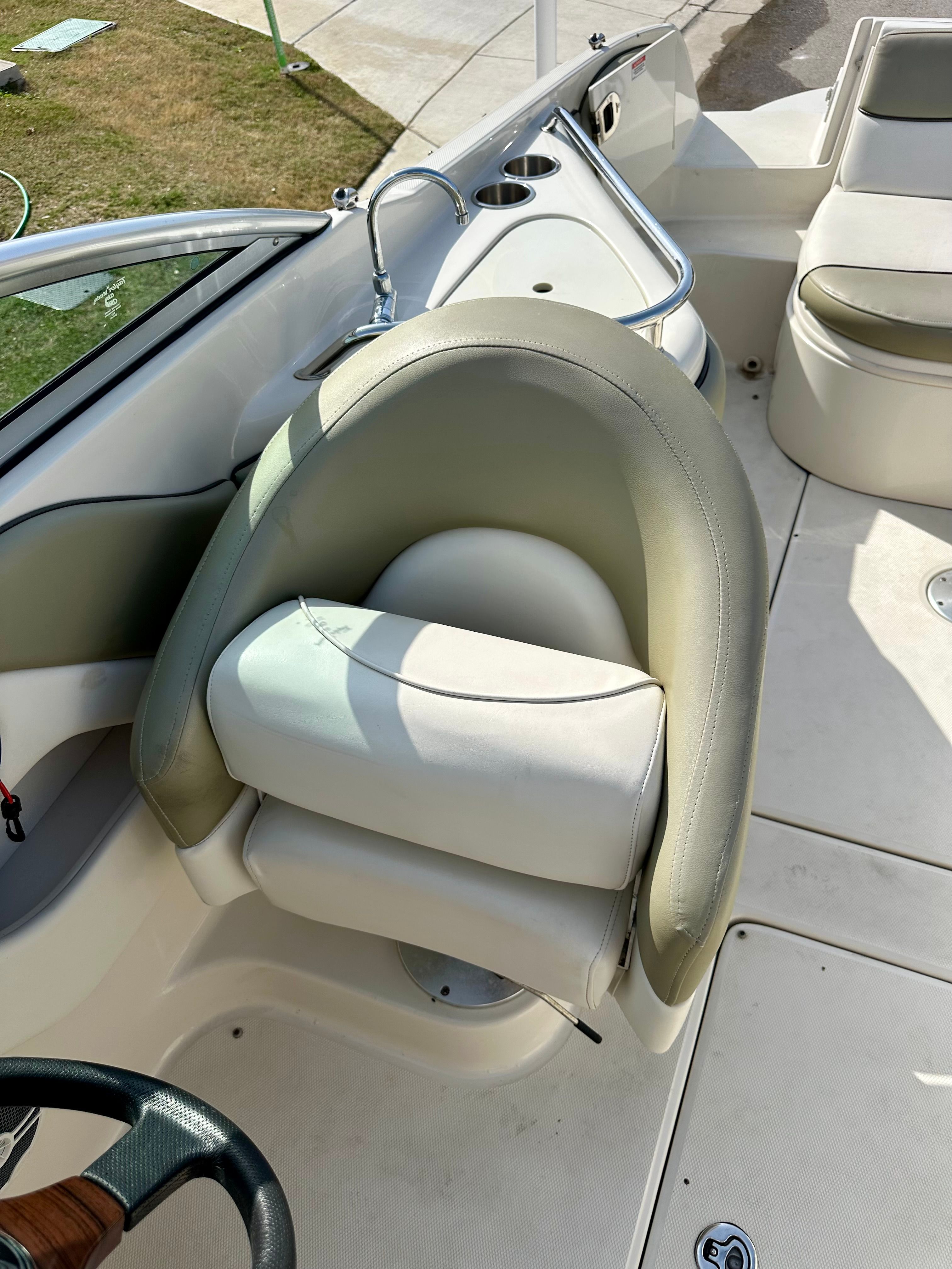 Interior of a 2006 Sea Ray 240 Sundeck with seating and controls.