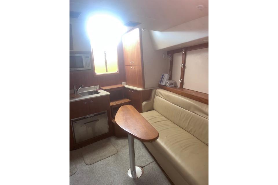 Interior of 2008 Albemarle 360 Express Fisherman with kitchenette and seating area.