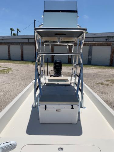 2013 SCB R24 boat with center console and outboard motor.