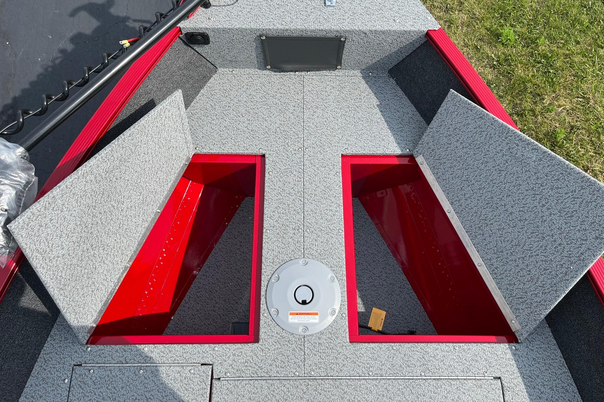 2026 Lund 1650 Angler SS boat storage compartments with open lids, gray and red interior.