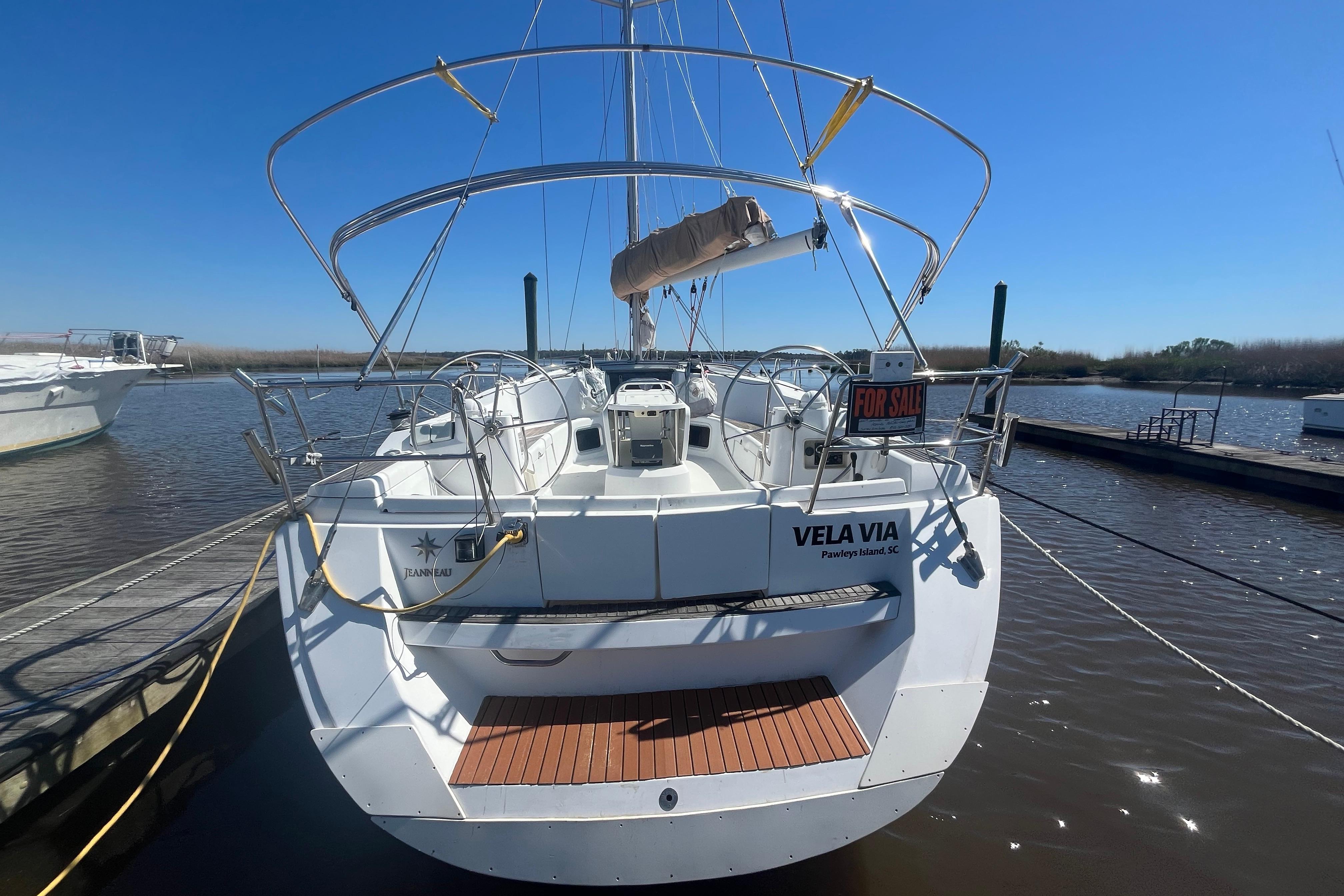 2009 Jeanneau Sun Odyssey 44i sailboat docked, rear view, for sale sign visible.