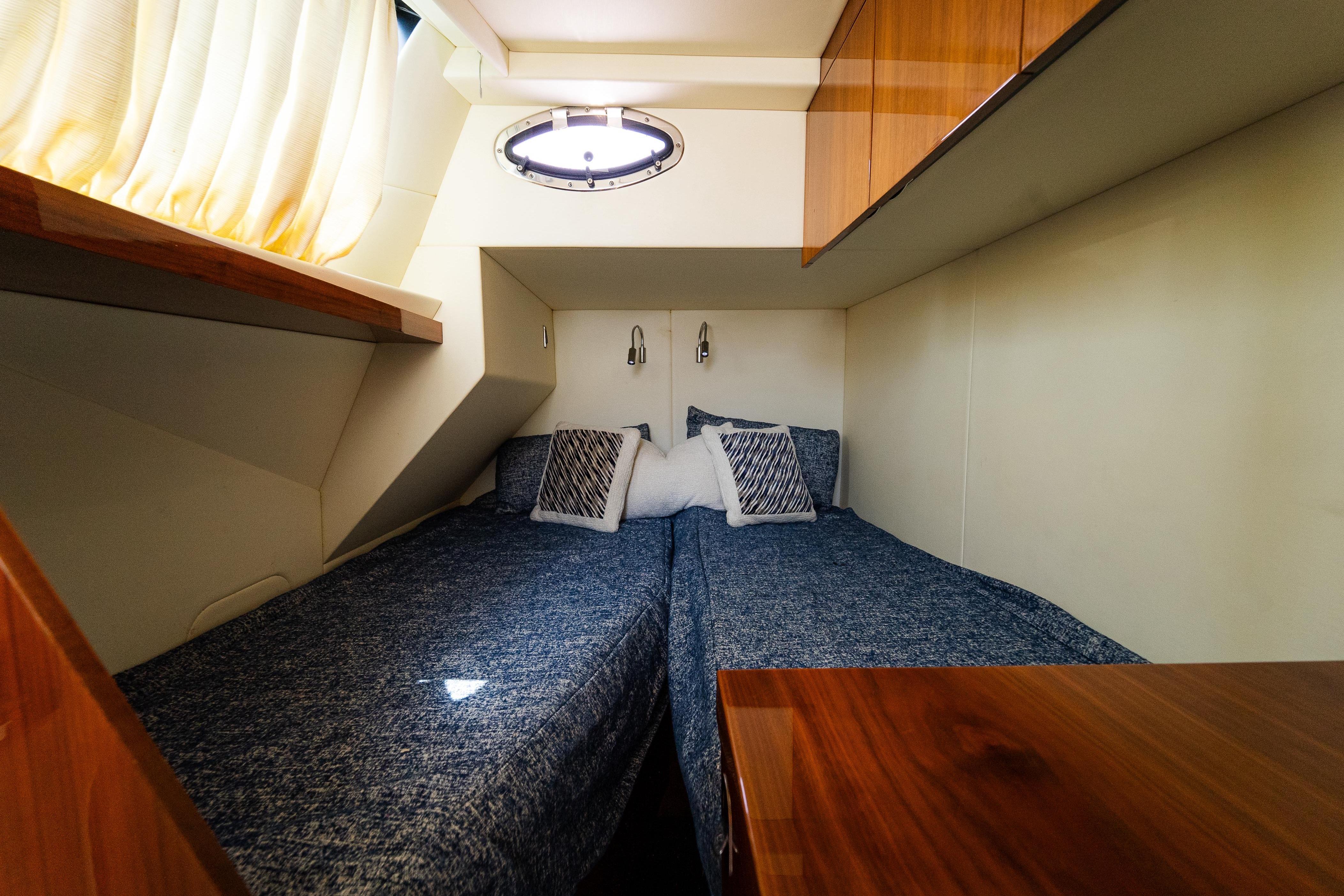 Cozy twin cabin in 2016 Sunseeker Manhattan 65 yacht with modern decor.