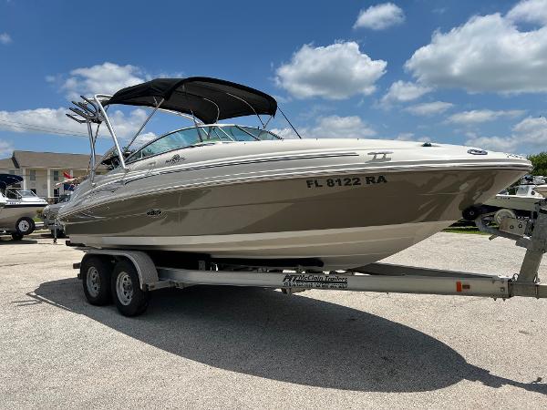 2005 Sea Ray 220 Sundeck boat on trailer under blue sky.