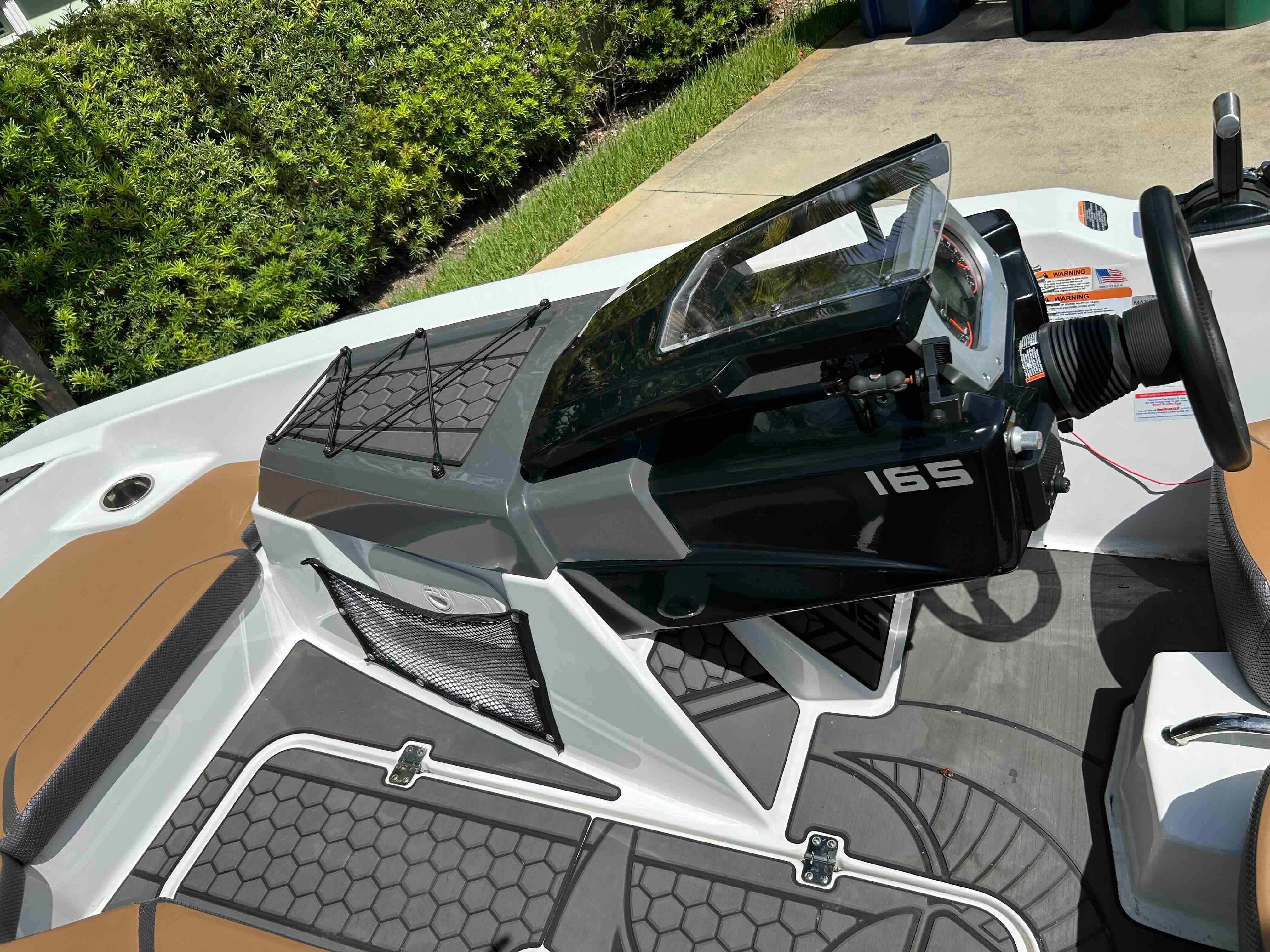 The image shows the cockpit of a 2022 Scarab 165 ID boat with modern controls.