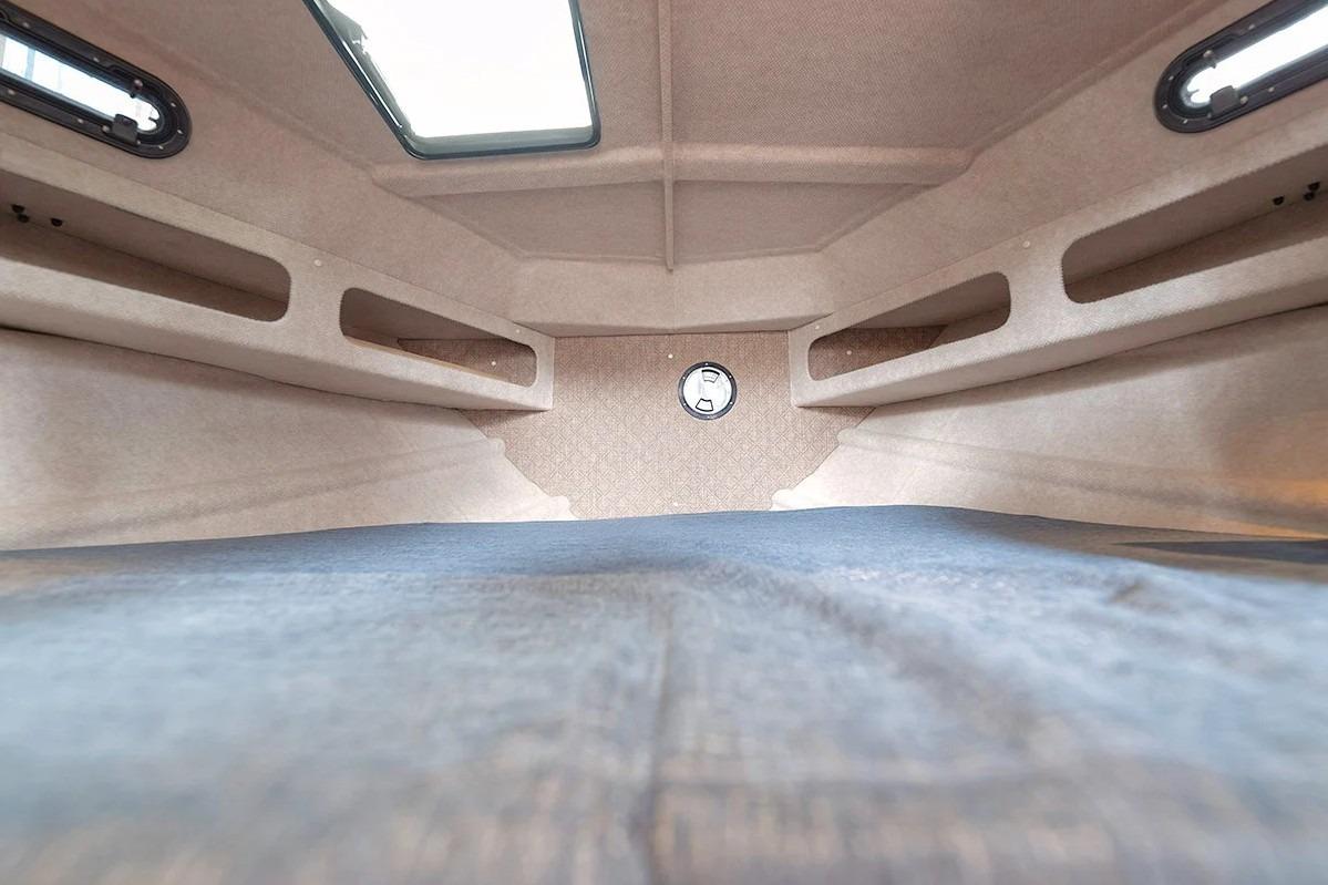 Interior cabin of 2026 KingFisher 3225 GFX Offshore boat, featuring spacious sleeping area.