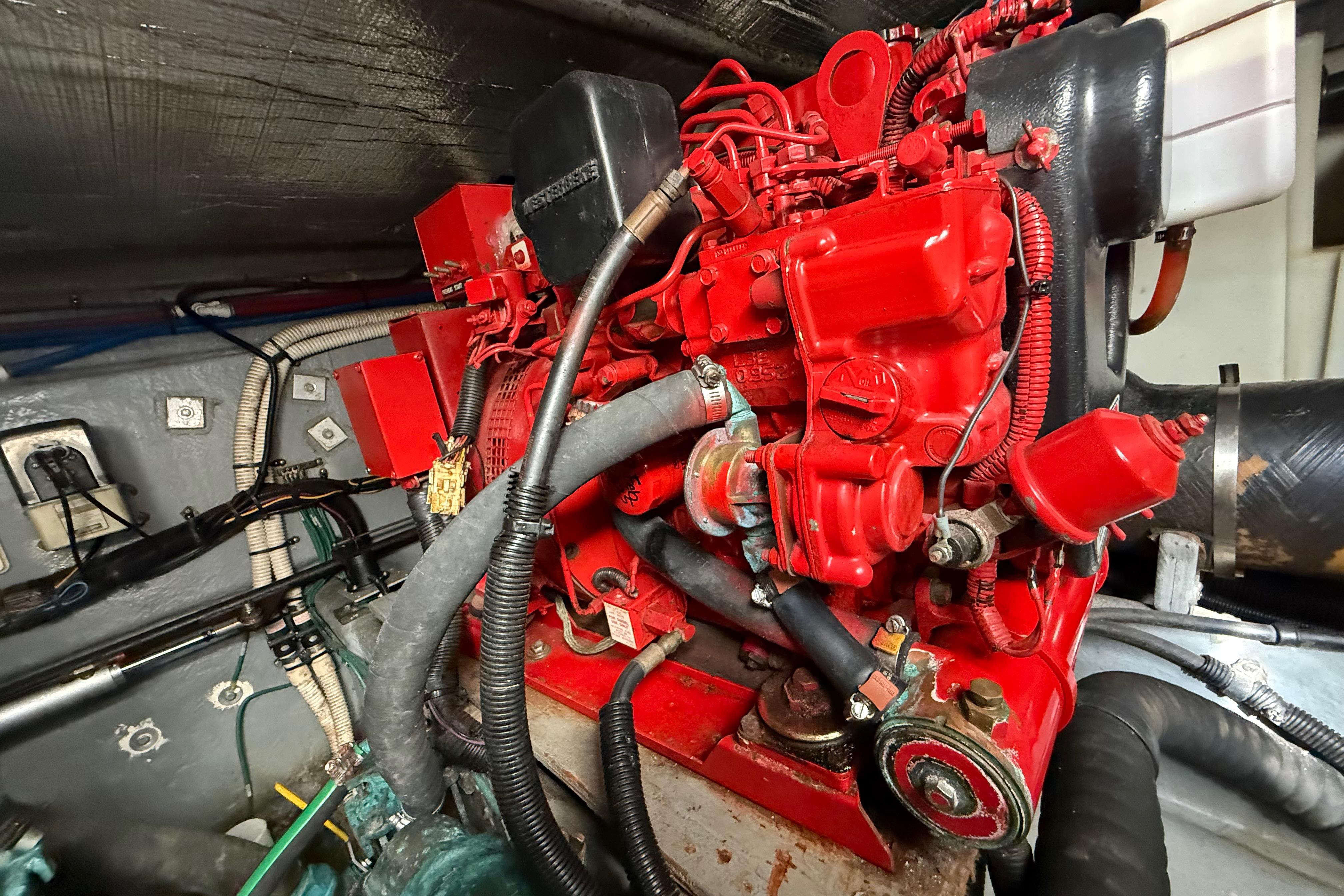 Engine compartment of a 1999 Sea Ray 410 Express Cruiser with red engine components.