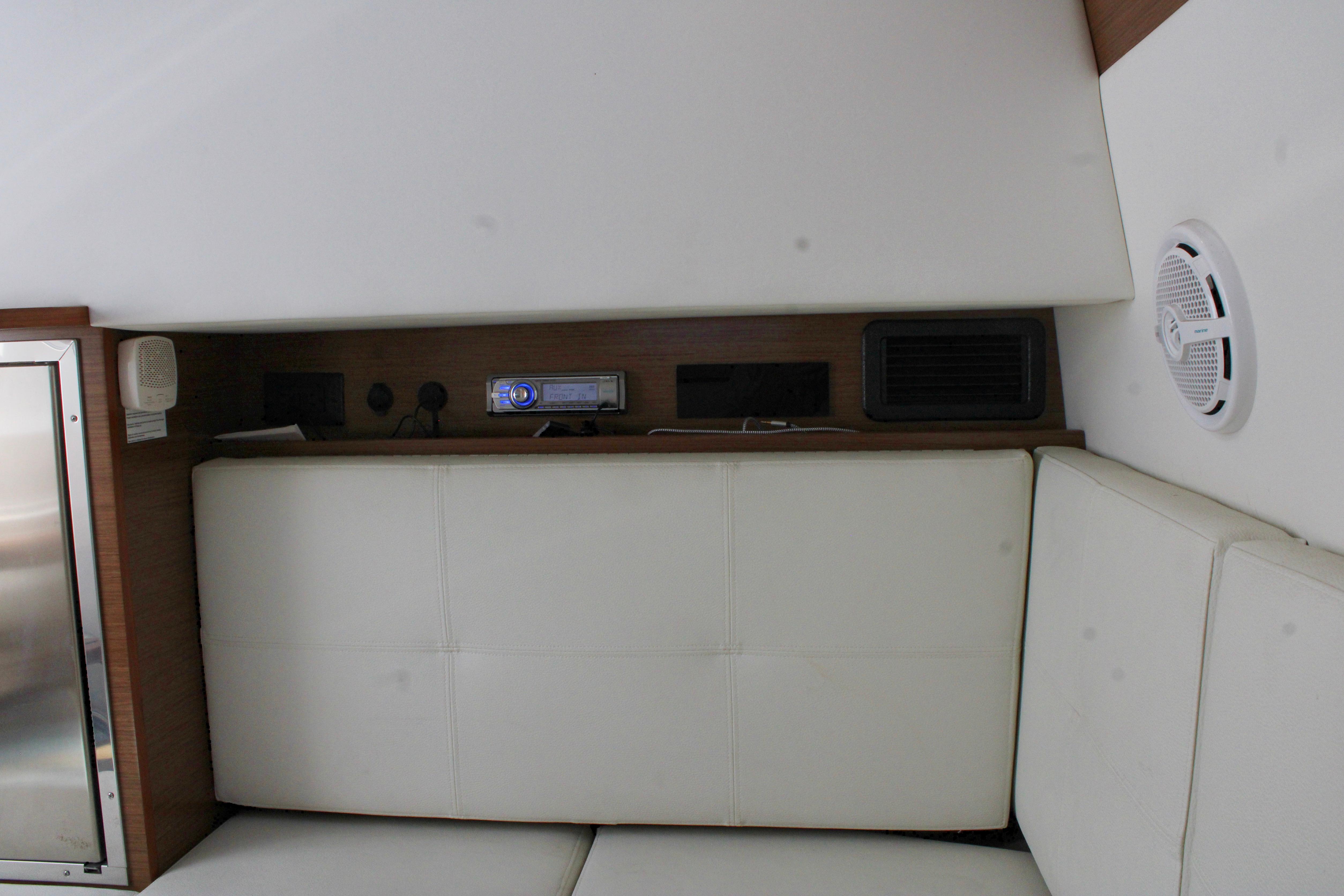 Interior of 2017 Cruisers Yachts 338 Bow Rider with white seating and audio system.