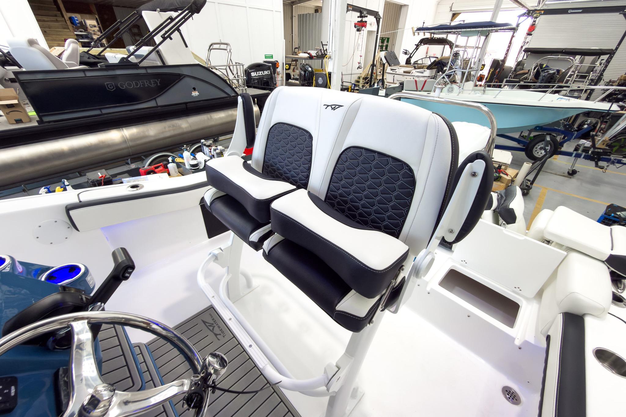 The image shows the cockpit of a Tidewater 220 LXF boat with modern seating and controls.