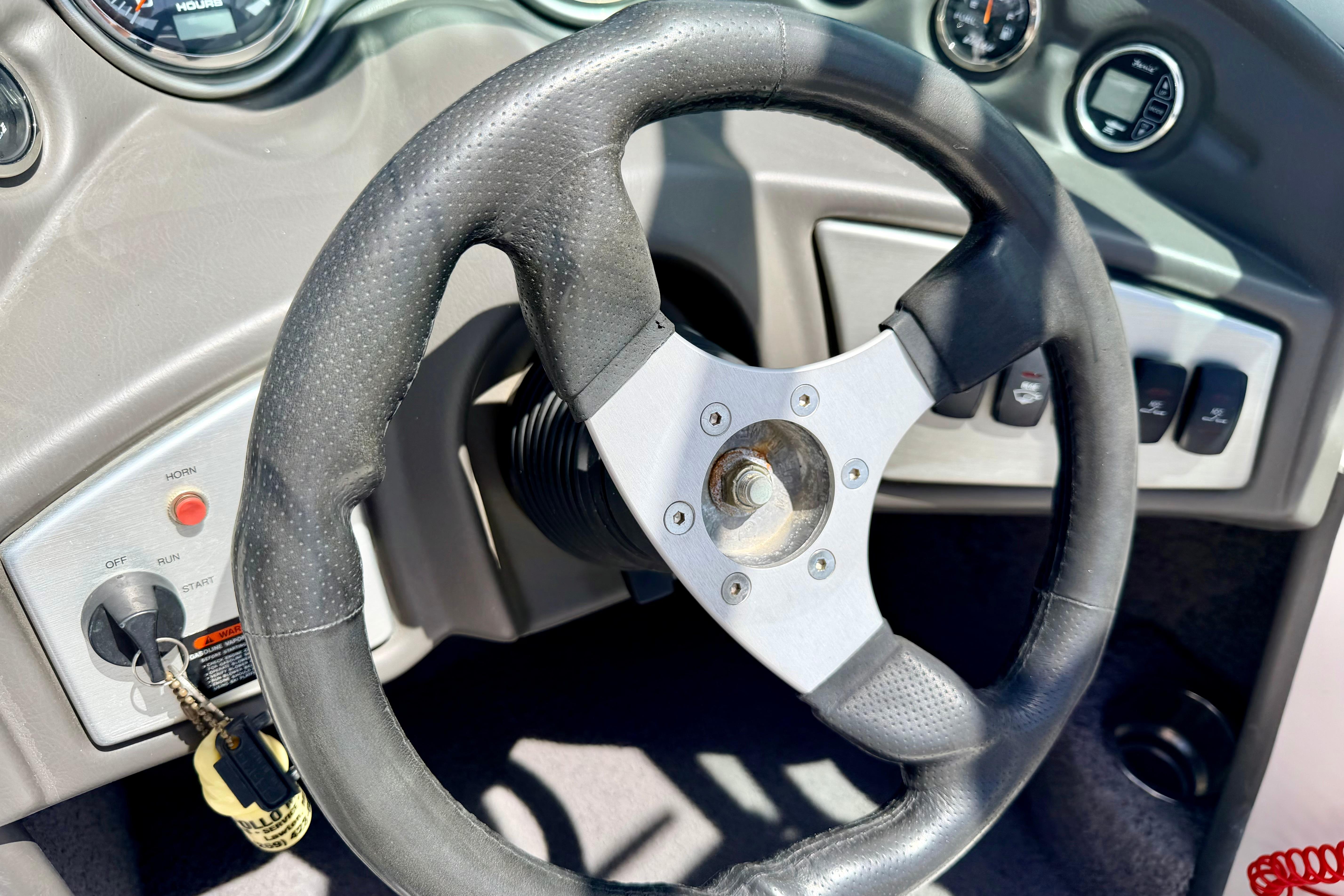 Steering wheel and dashboard of a 2008 Moomba Outback V boat.
