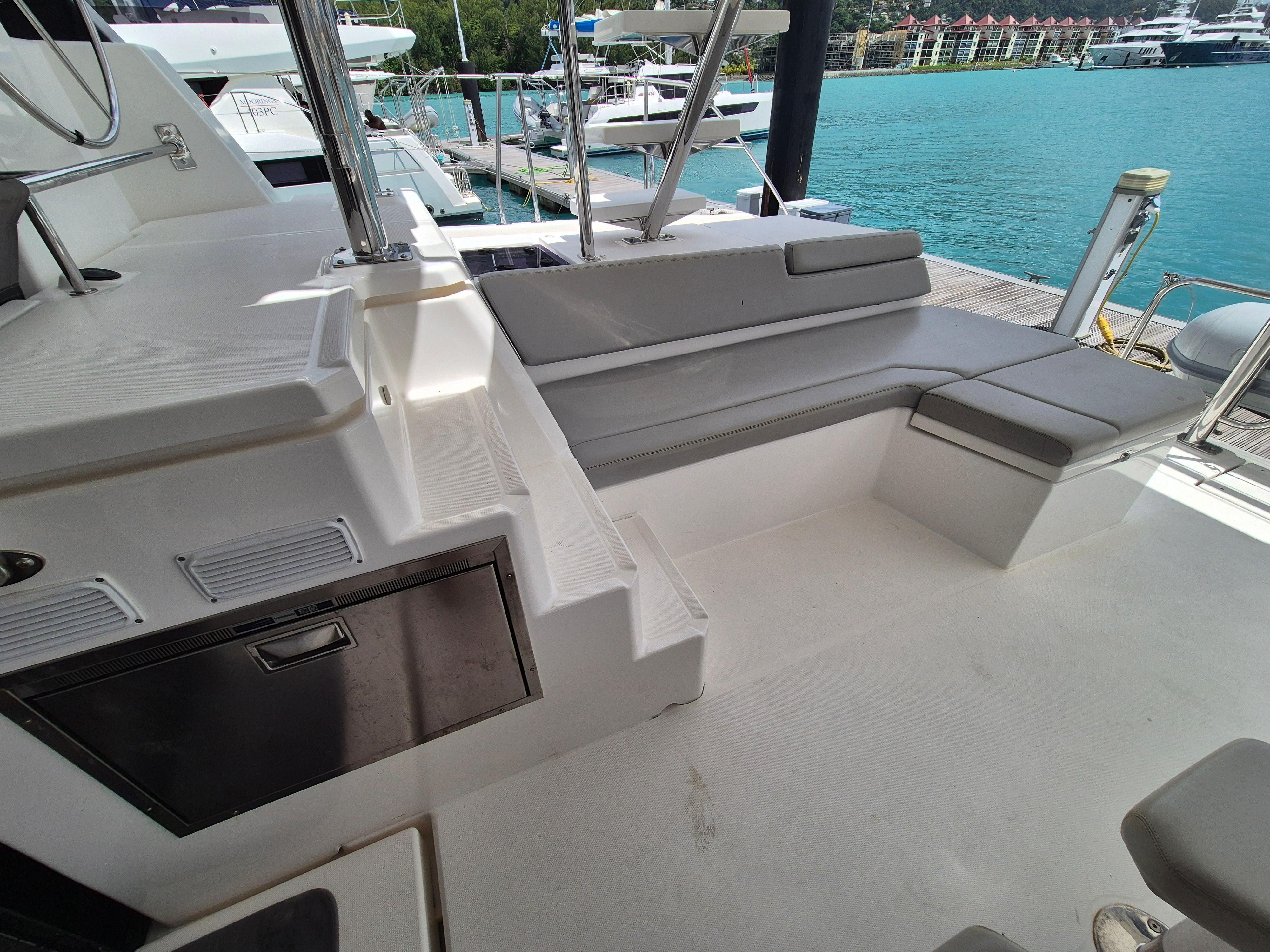 Leopard 50 yacht deck with seating, docked by turquoise water, 2020 model.