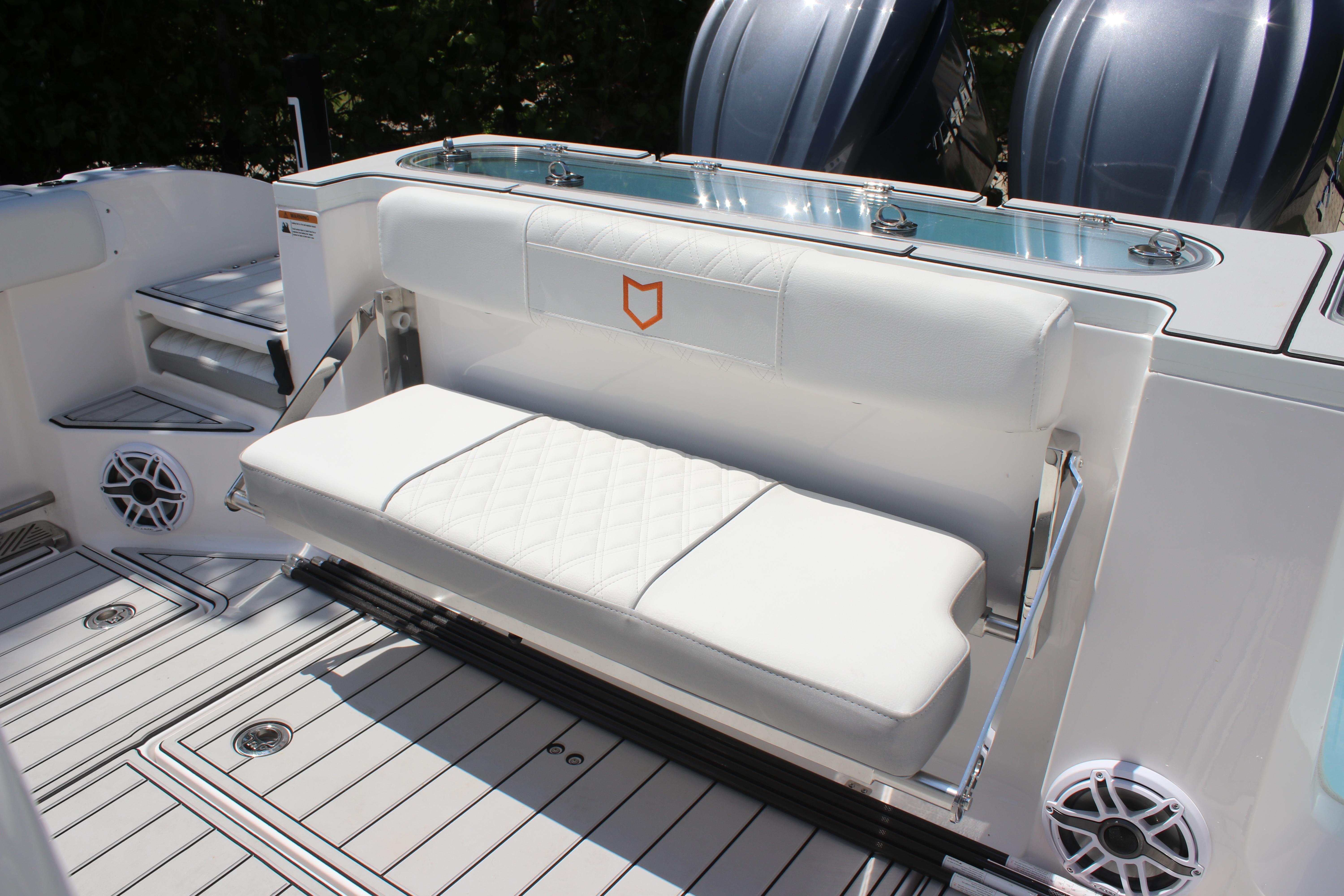 2025 Sea Fox 328 Commander boat interior with white cushioned seating and sleek design.