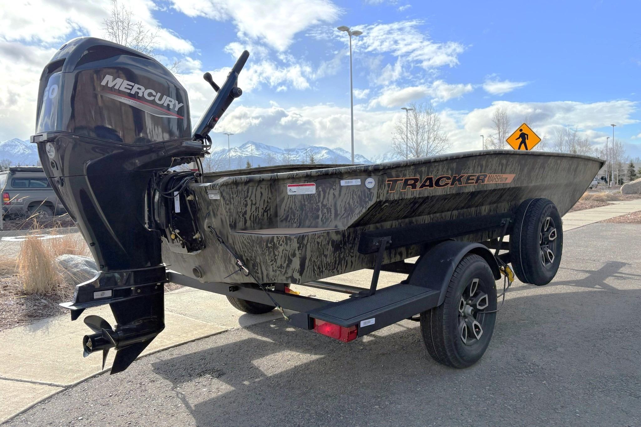 2026 Tracker Grizzly 1756 T Marsh boat with Mercury engine on trailer, scenic mountain backdrop.