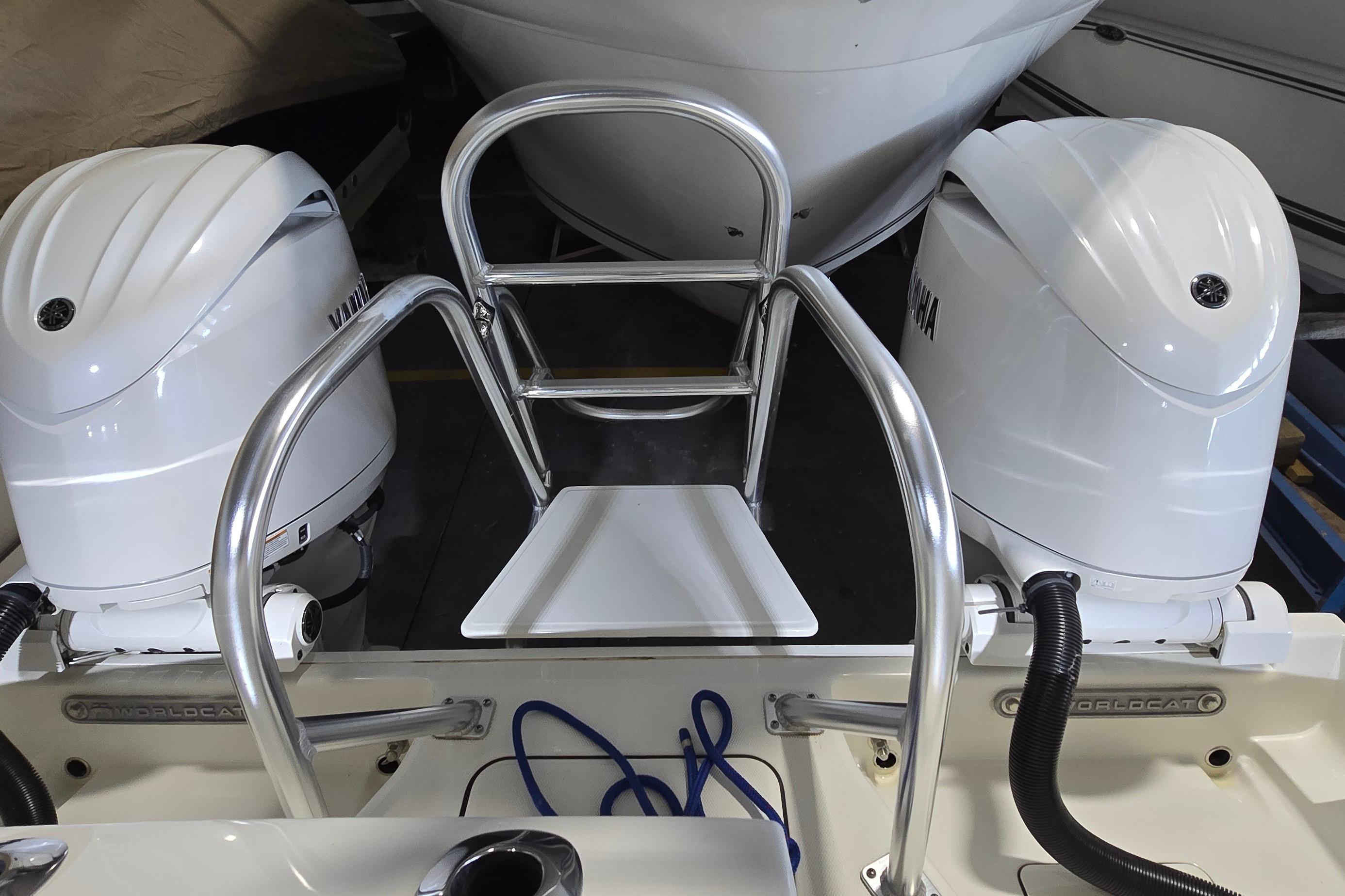 2024 WorldCat 280 CC-X boat with dual Yamaha outboard engines and stainless steel ladder.