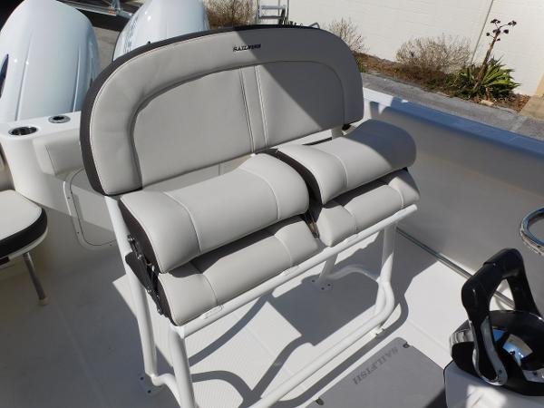 2024 Sailfish 242 CC boat with cushioned seating and dual outboard motors.