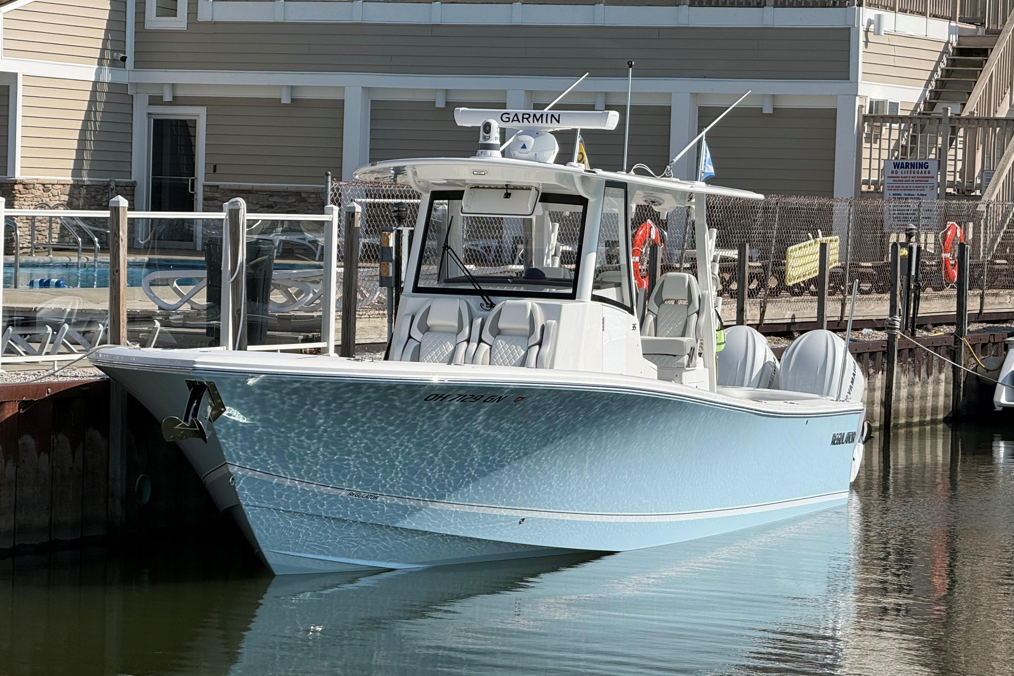 2026 Regulator 35 boat docked, featuring Garmin equipment, in a marina setting.