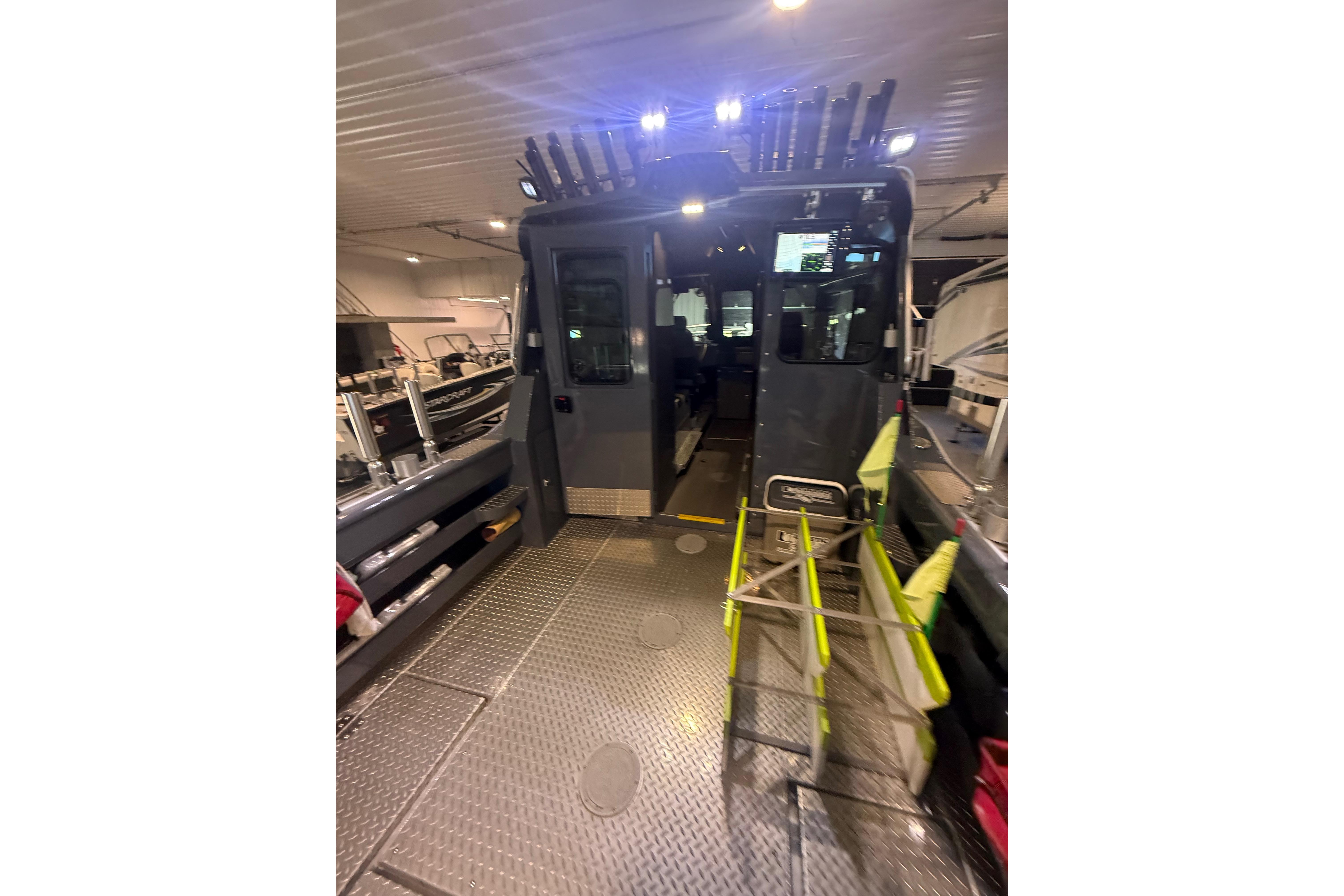 2022 Hewescraft 270 Alaskan Hardtop interior with fishing rod holders and equipment.