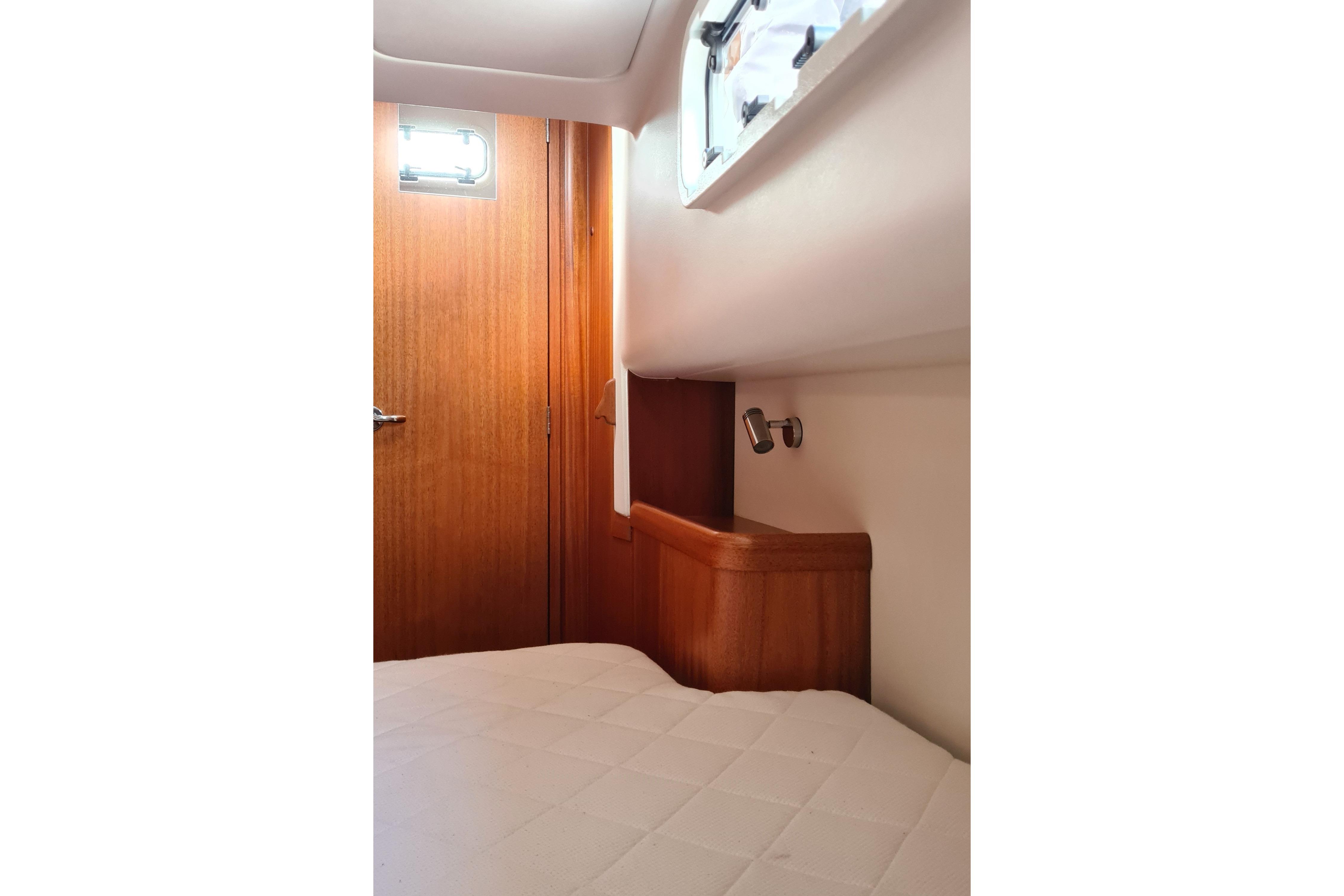 Interior cabin of 2018 Arcona 435 yacht with wooden door and window.