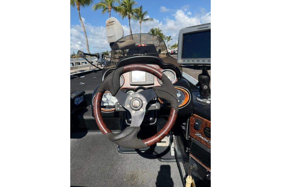 2005 Triton Tr-21X PD boat dashboard with steering wheel and navigation system.