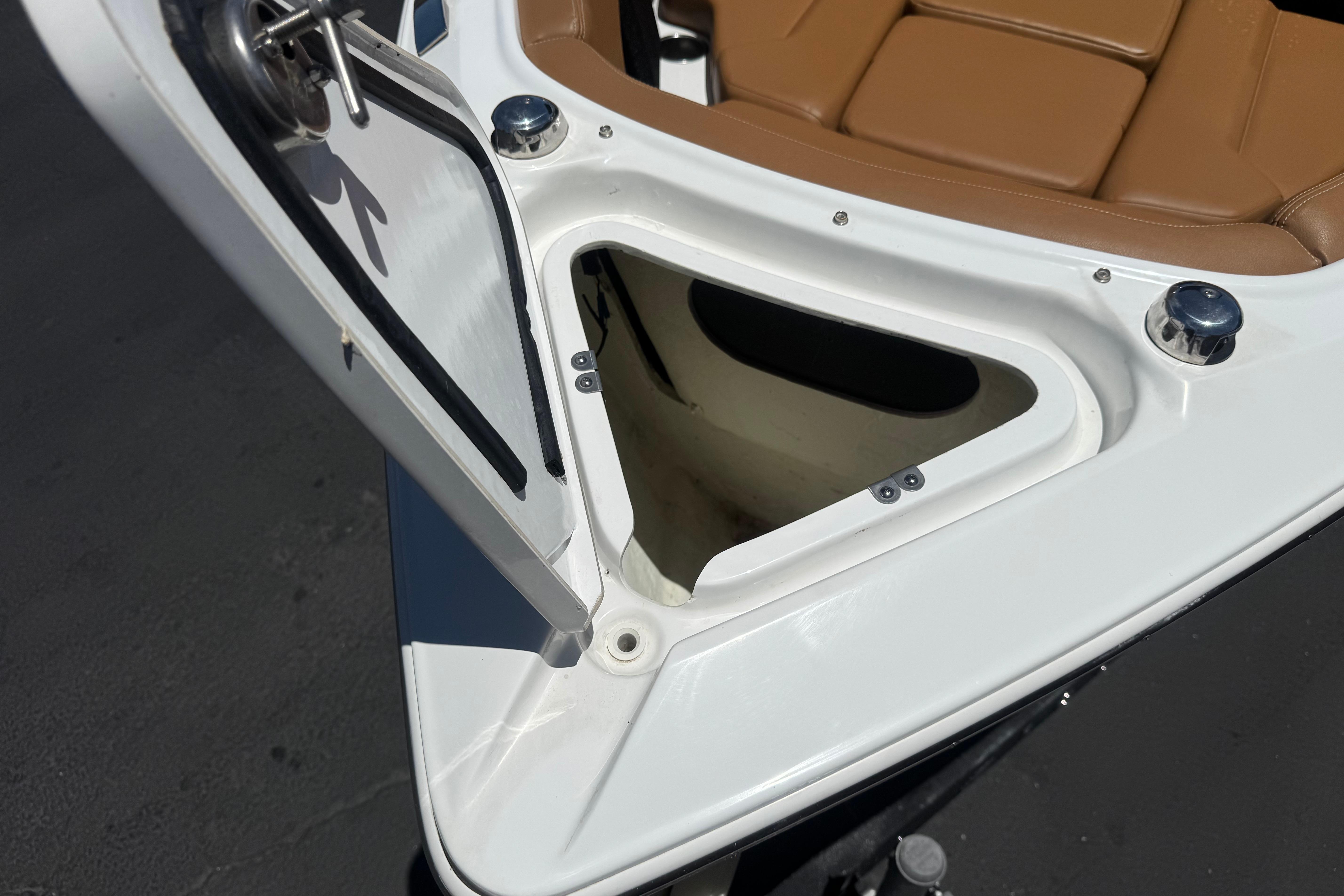 Bow storage compartment of 2022 Four Winns H4 boat with tan seating.