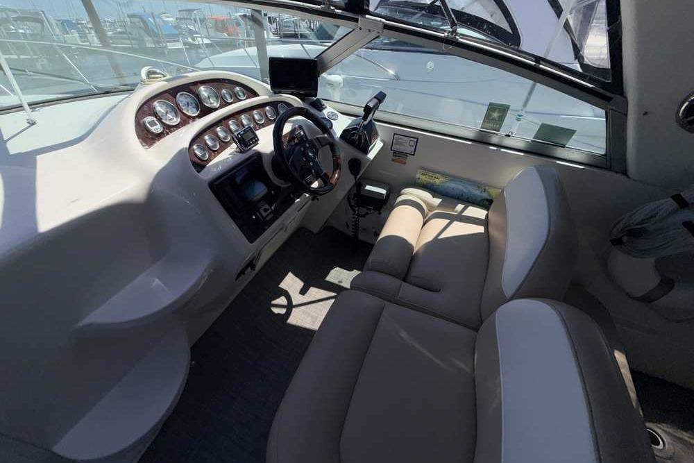 Interior of a 2001 Monterey 282 Cruiser boat with steering wheel and dashboard.