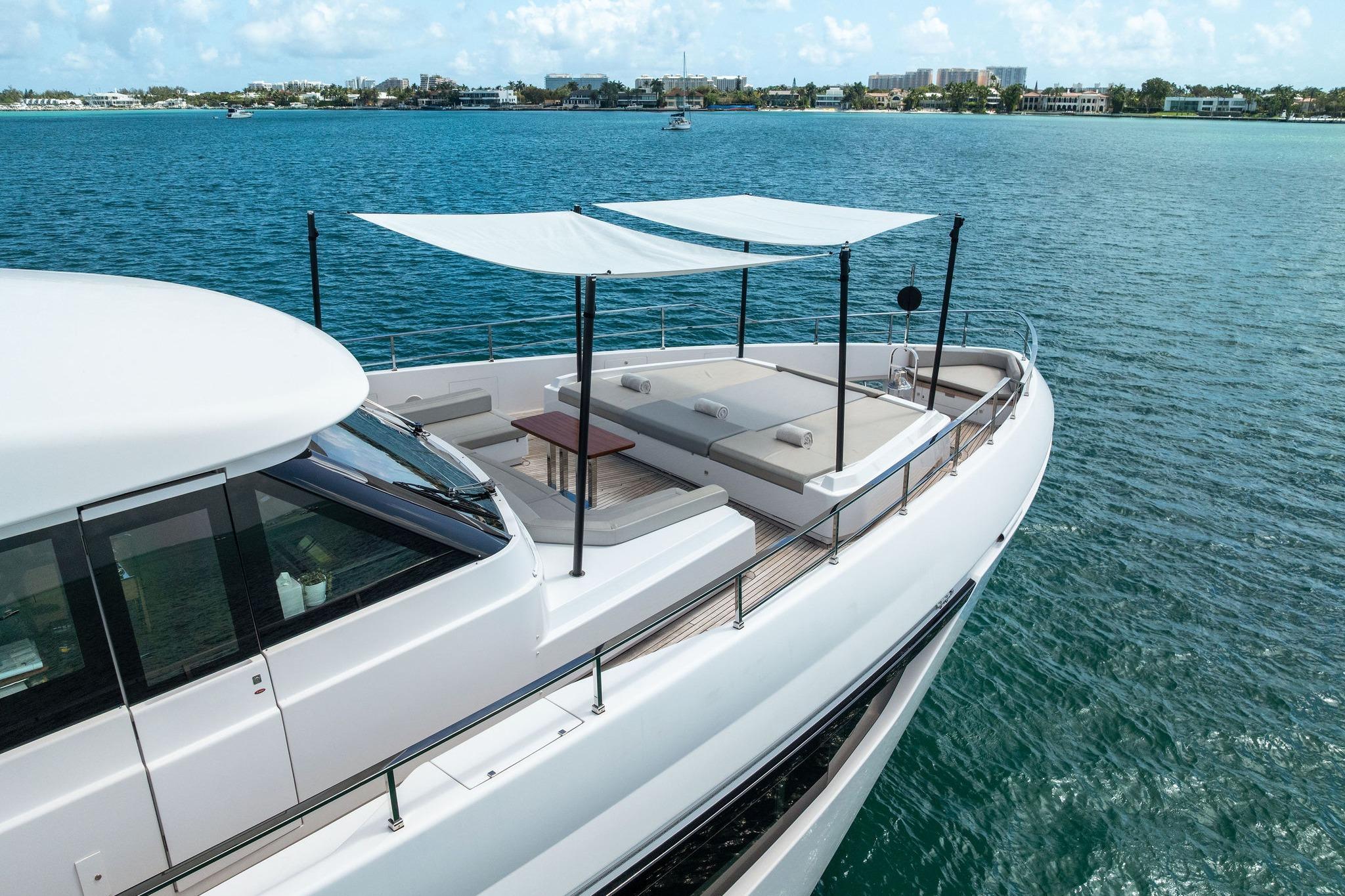 Luxurious 2023 Custom Line Navetta 33 yacht cruising on serene blue waters.