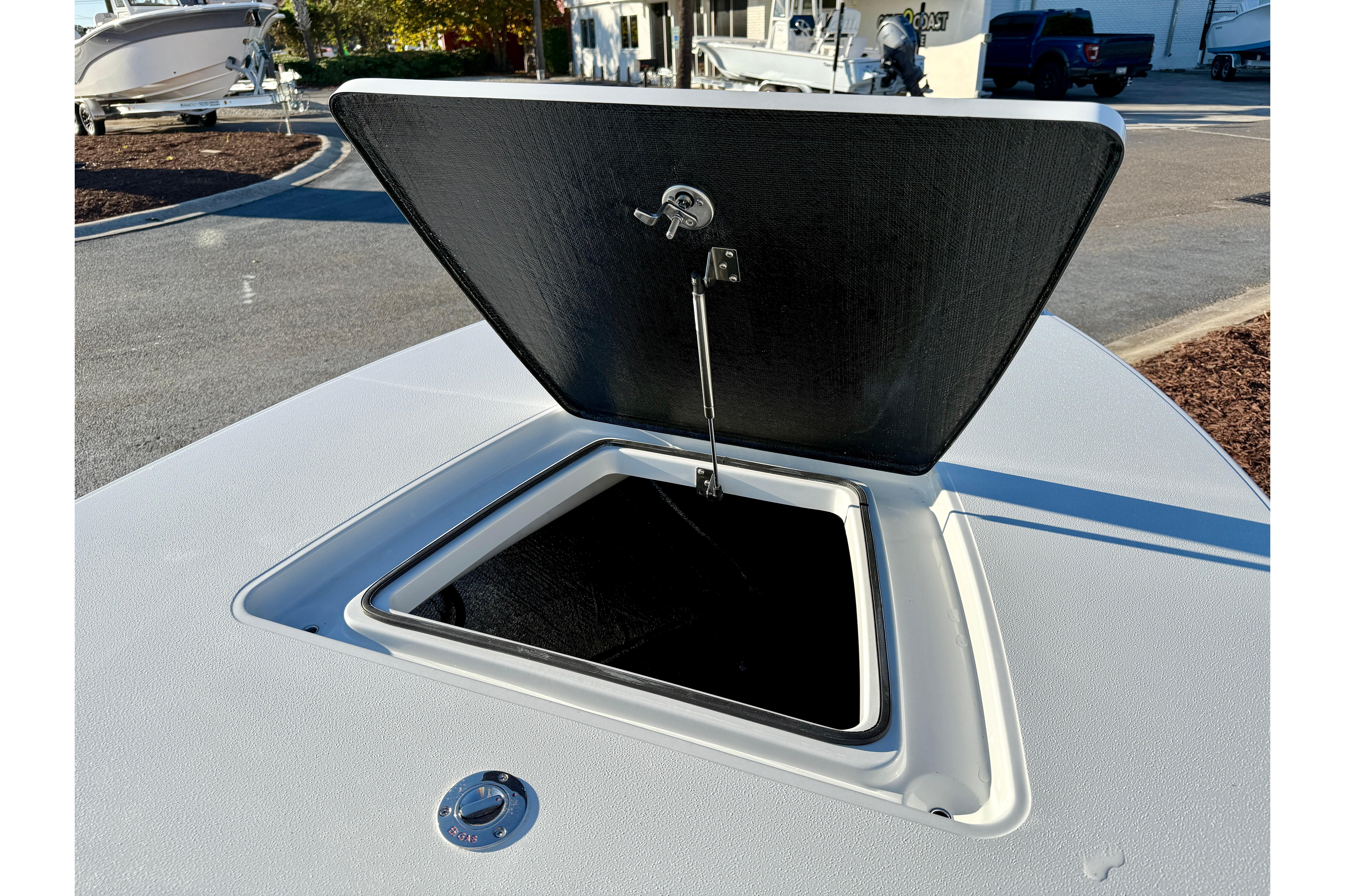 Open storage compartment on 2026 East Cape EVO 17V boat deck.