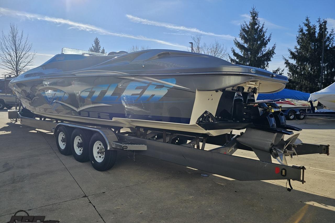 2007 Hustler 41 Razor speedboat on trailer, sleek design, parked outdoors.