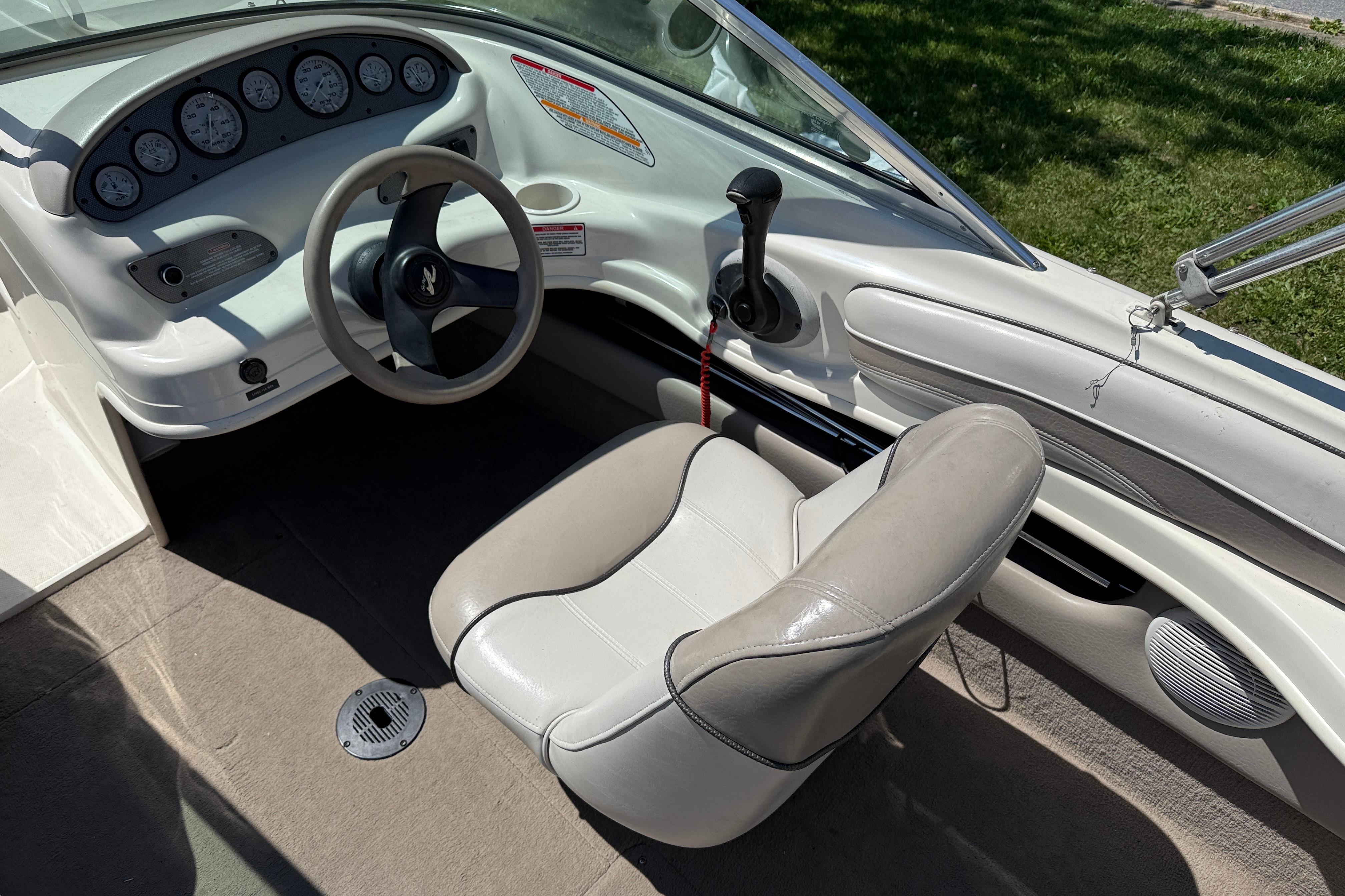 2003 Sea Ray 182 Bow Rider cockpit with steering wheel and gauges.