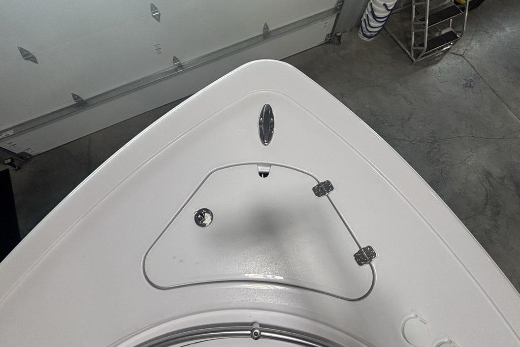 Bow of 2026 Sportsman Open 252 Center Console boat in a garage setting.