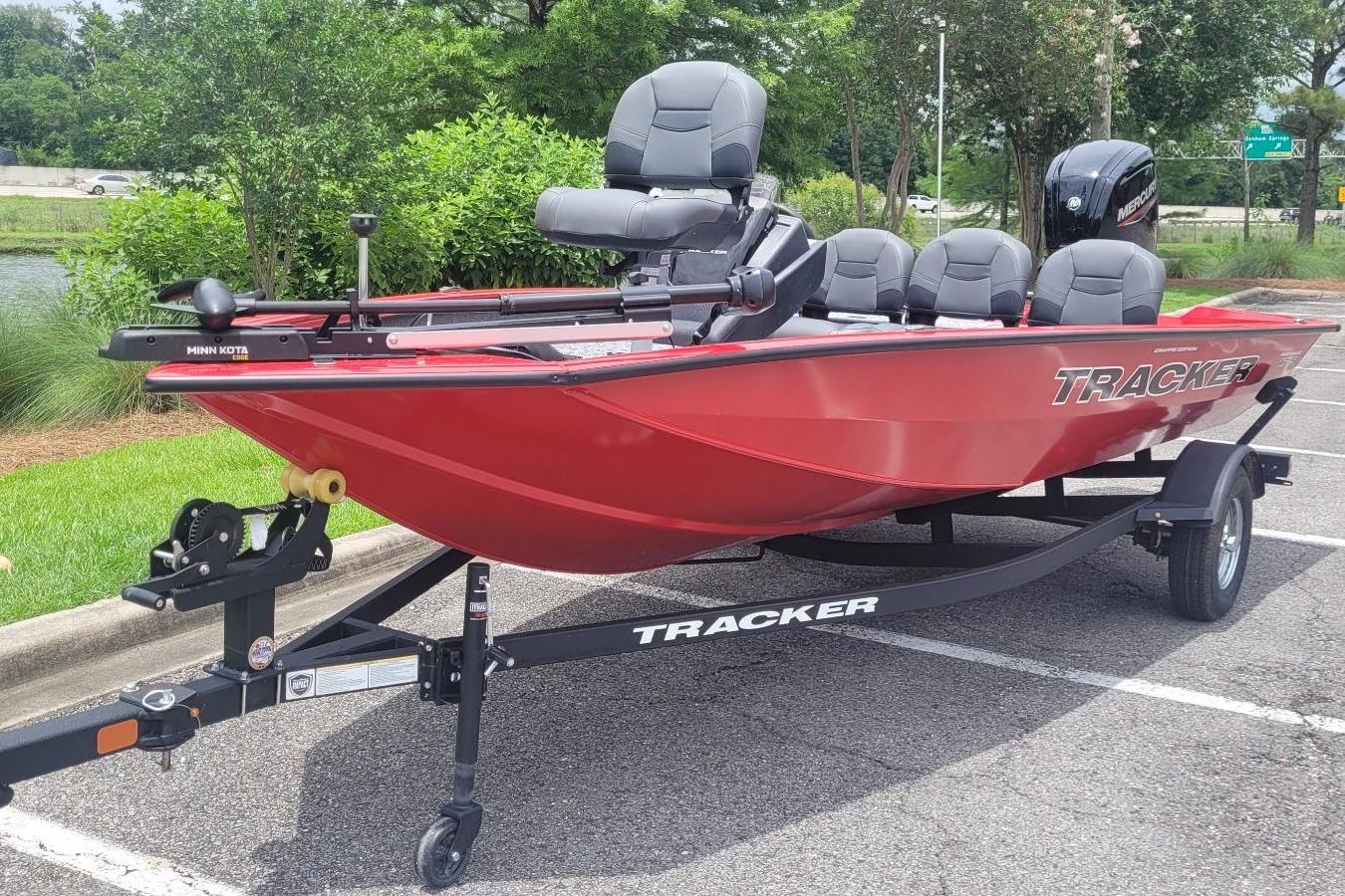 2026 Tracker Pro Team 175 Crappie Edition boat in vibrant red, parked outdoors.