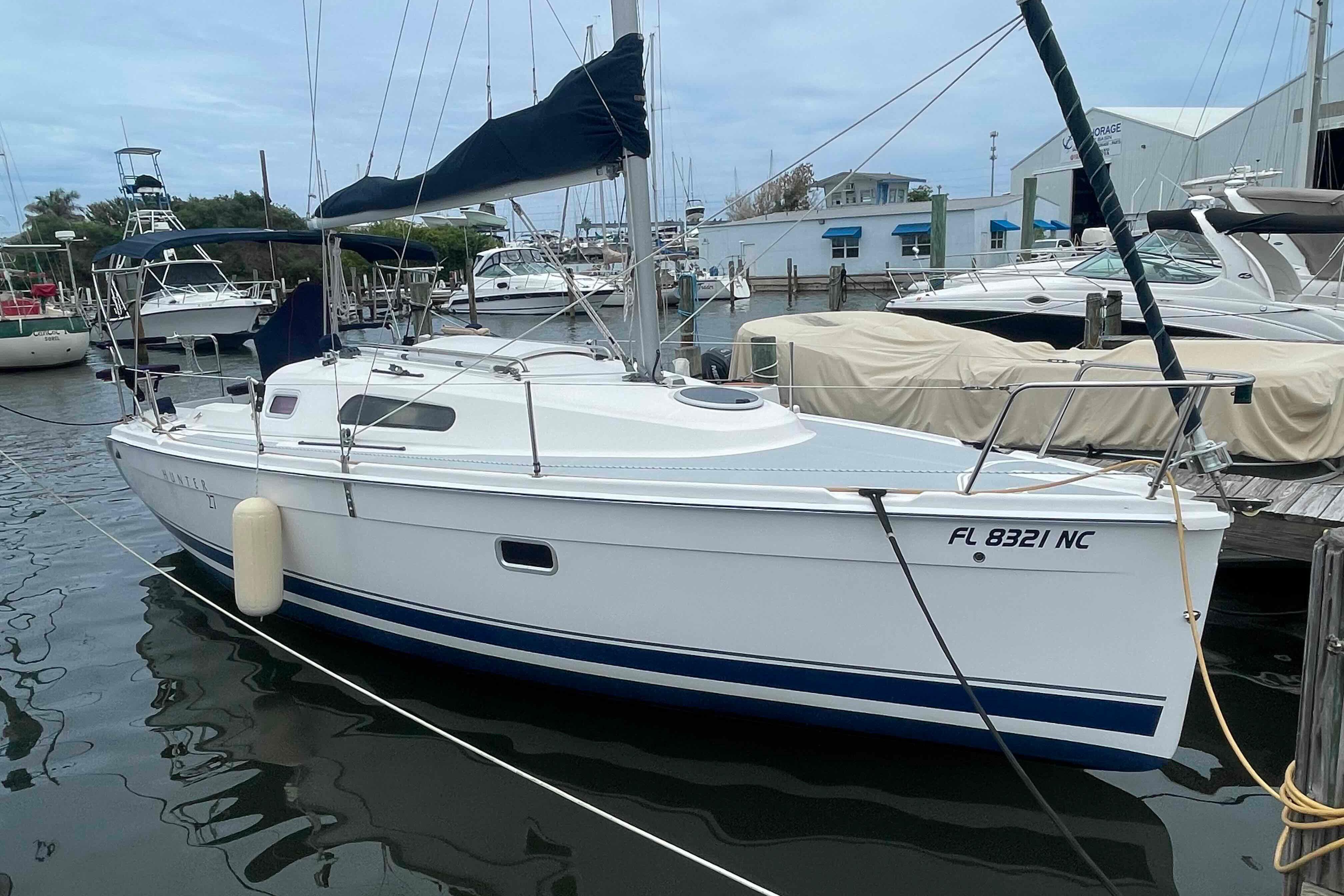 2006 Hunter 270 sailboat docked at marina, featuring sleek design and white hull.