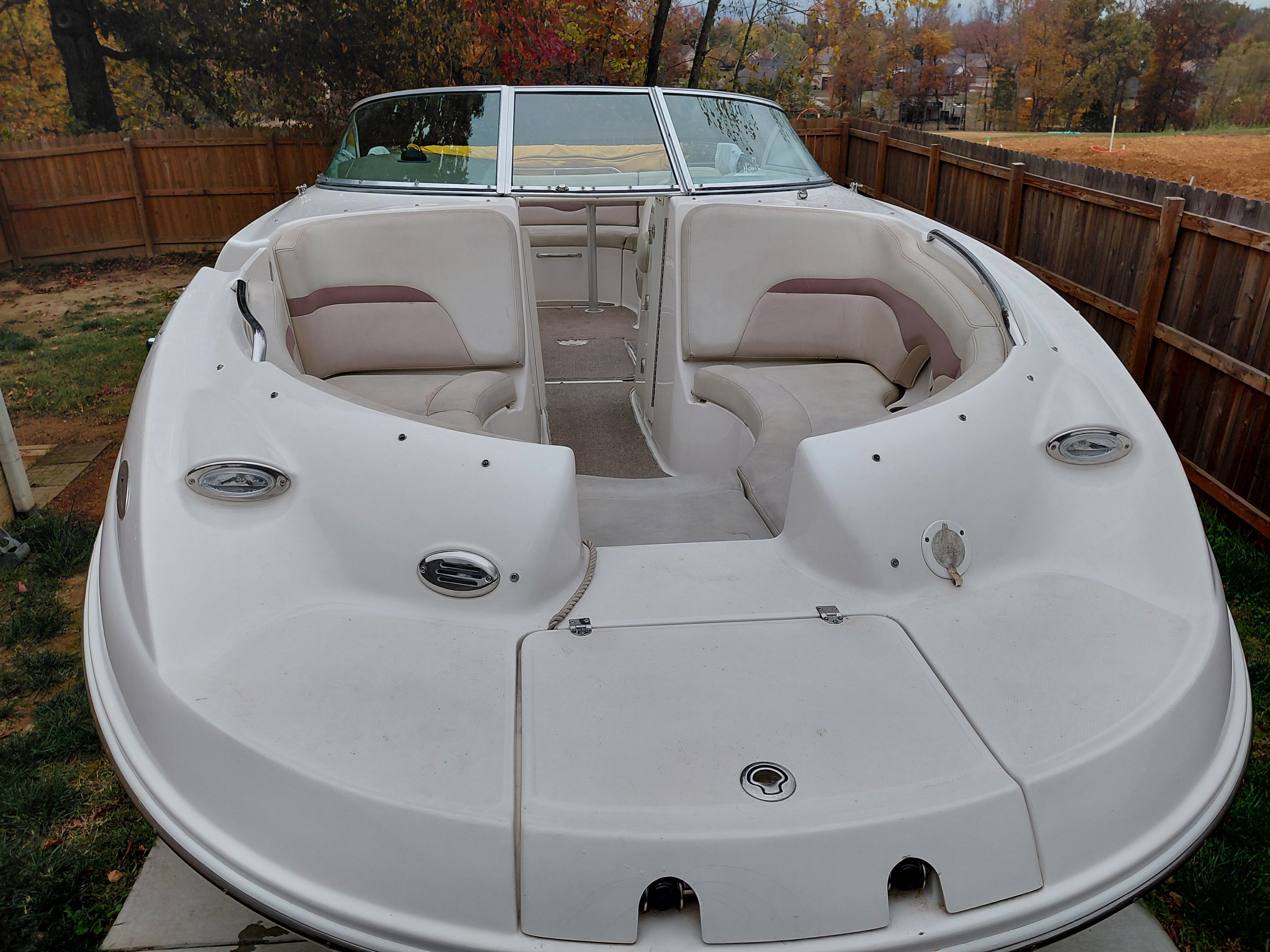 2005 Chaparral Sunestra 254 boat with open cabin in backyard.