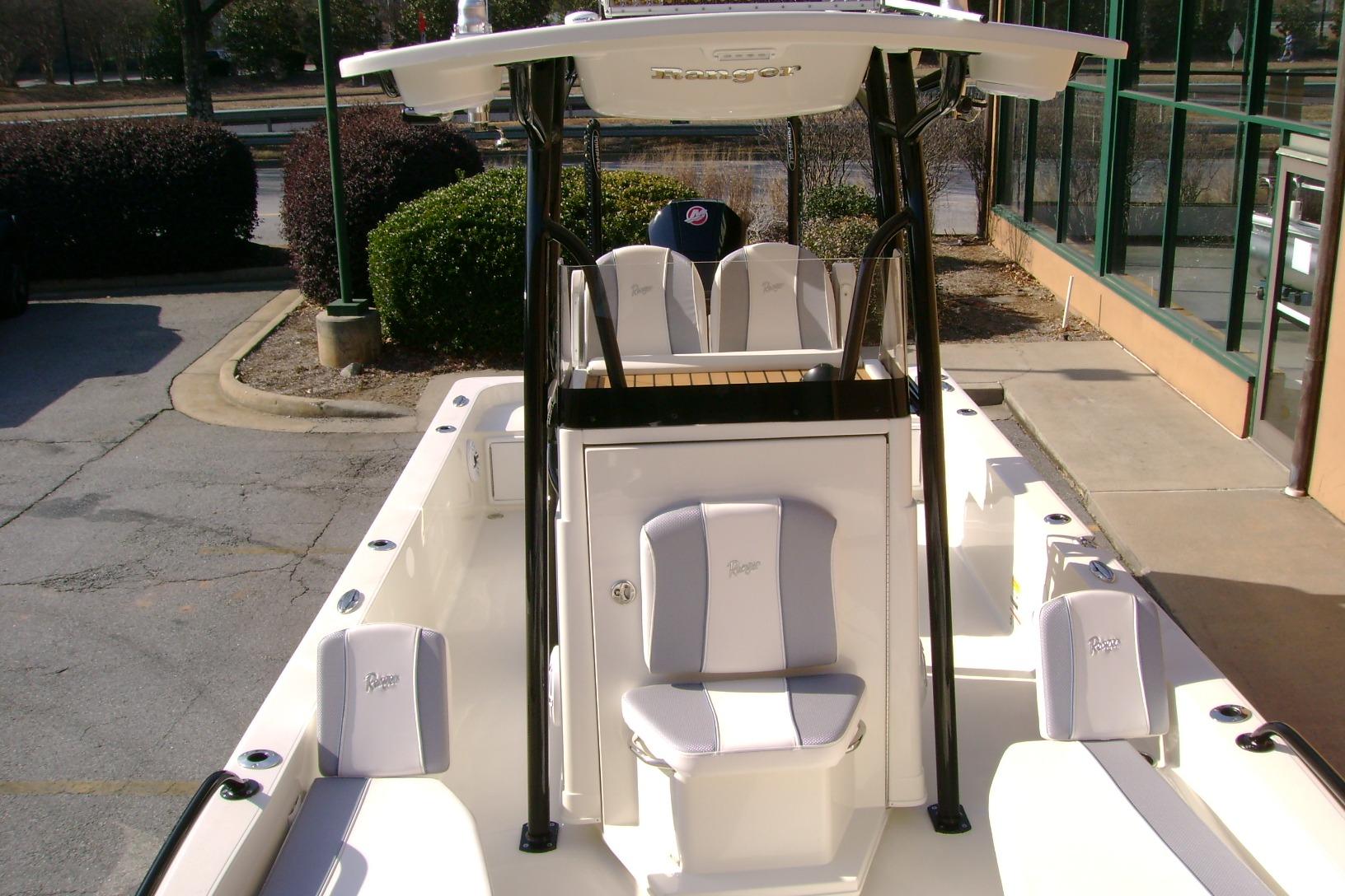 2026 Ranger 2360 Bay boat interior with seating and console, parked outdoors.