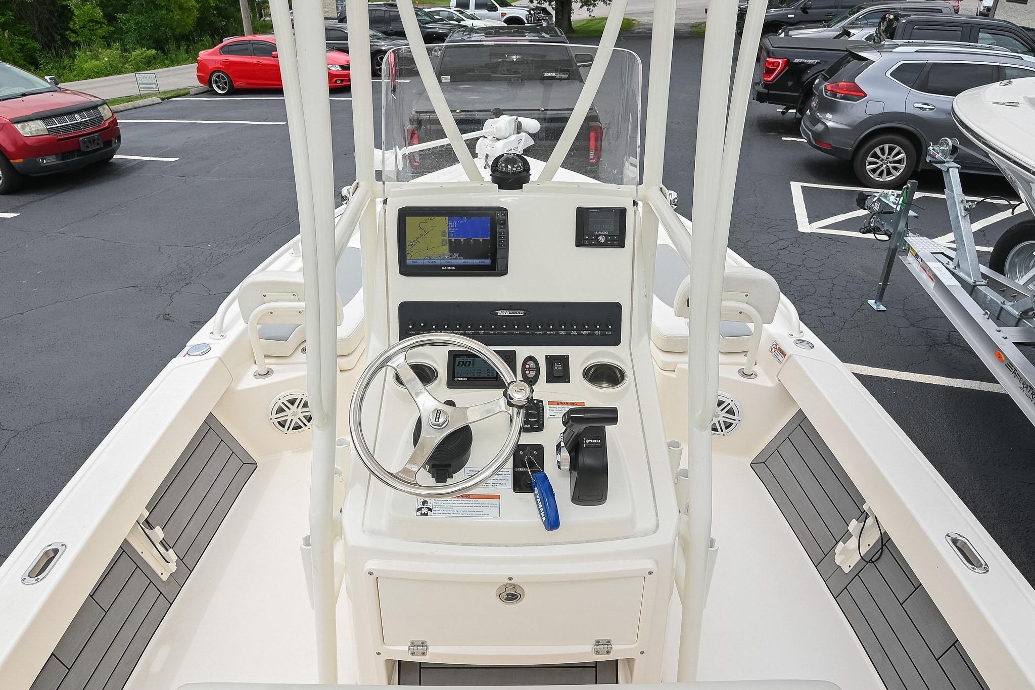 2021 Pathfinder 2200 TRS boat dashboard with steering wheel and navigation display.