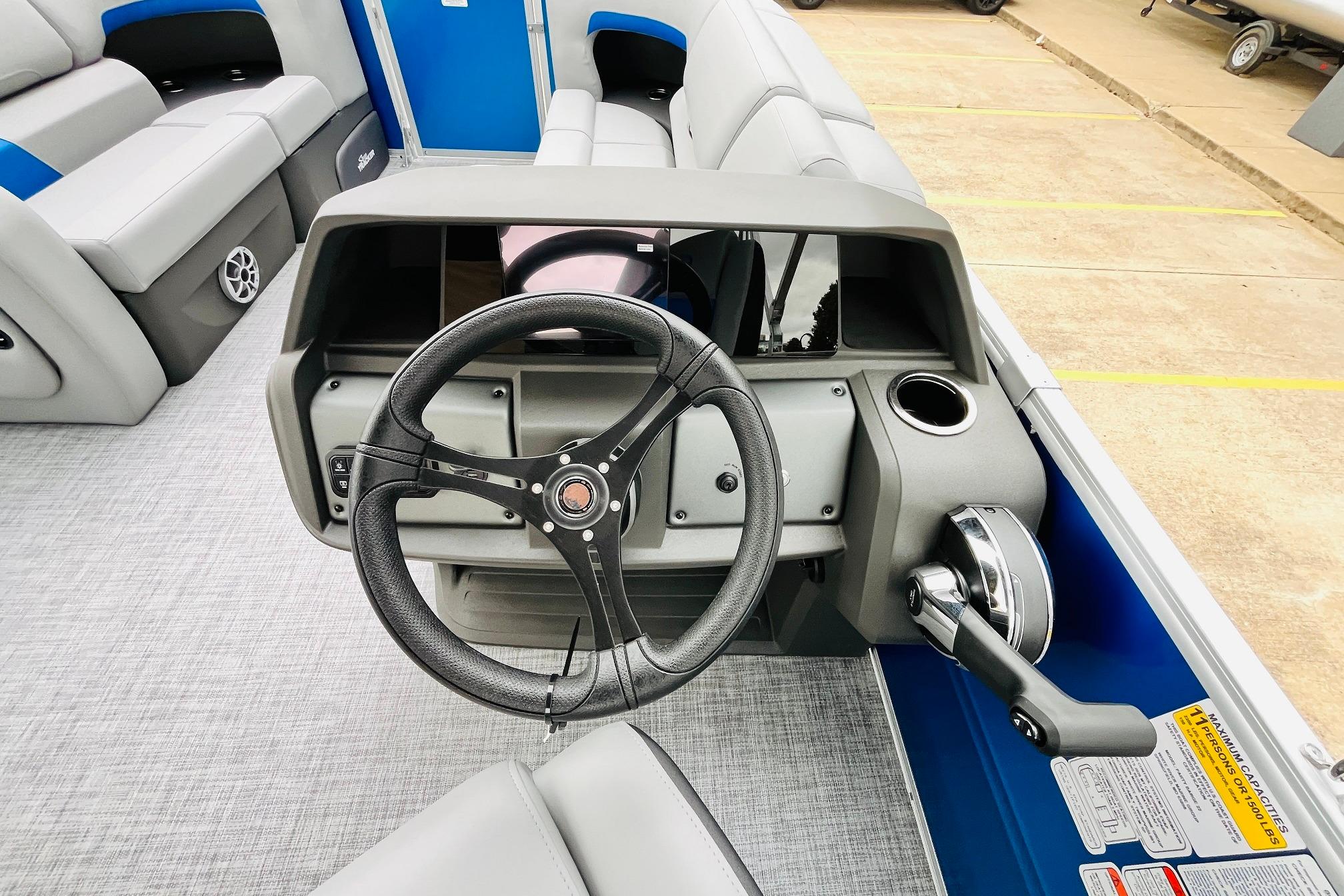 2026 Sun Tracker Party Barge 22 RF DLX steering console with modern controls and seating.