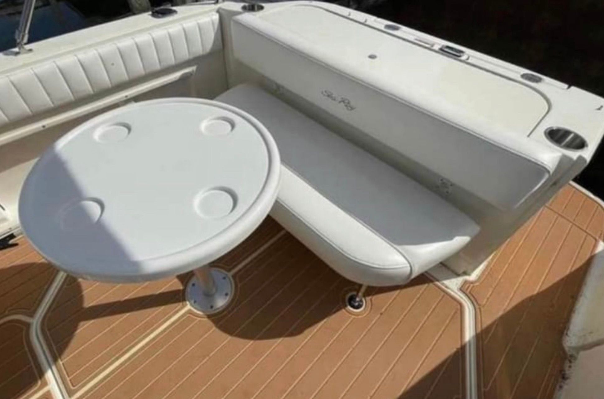 Interior of 2006 Sea Ray 270 Amberjack with table and bench seating.