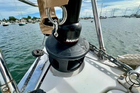 Tartan 345 sailboat deck with winch, anchored in a marina, 2021 model.