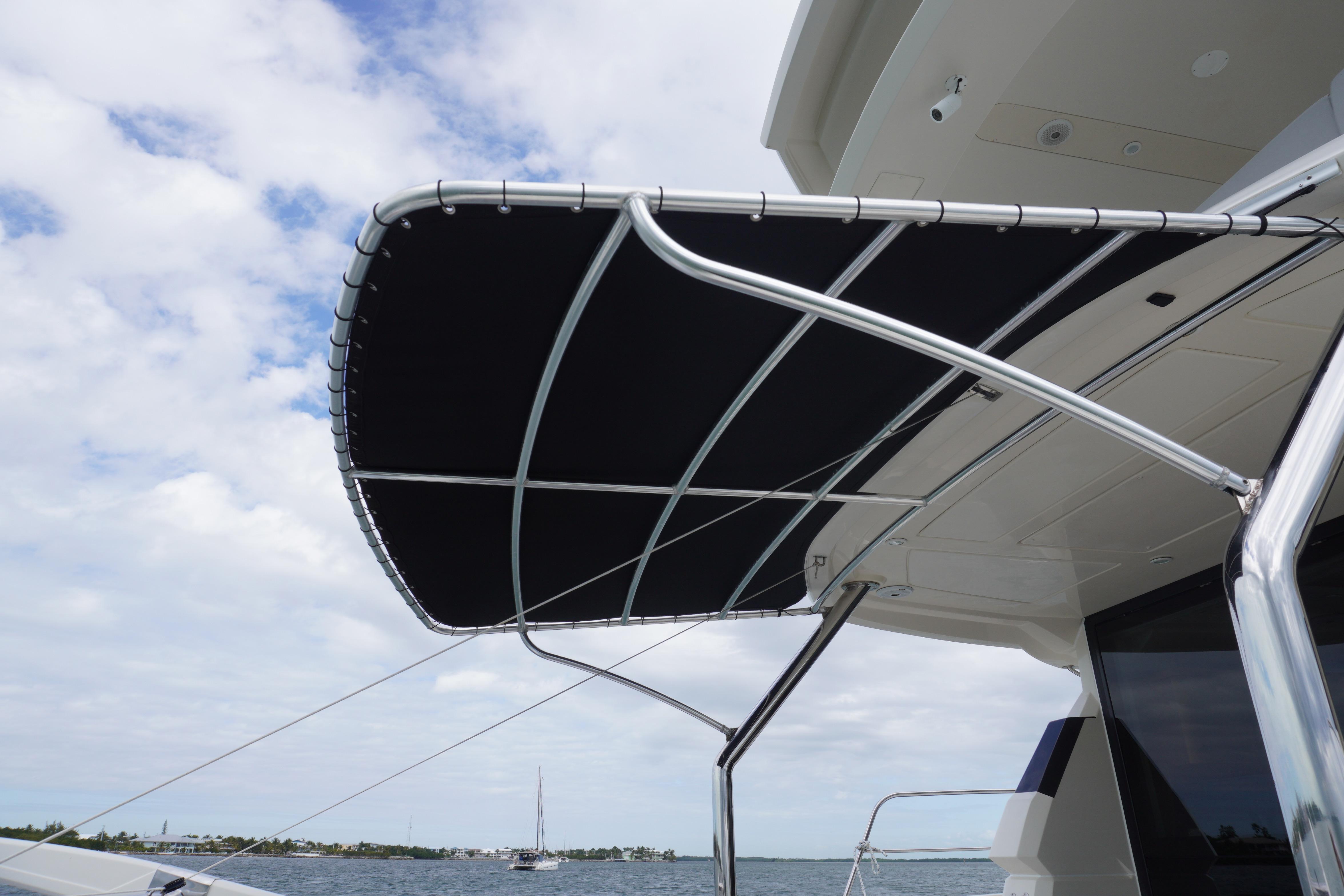 Aquila 44 Yacht 2017 with sleek black canopy against a cloudy sky.