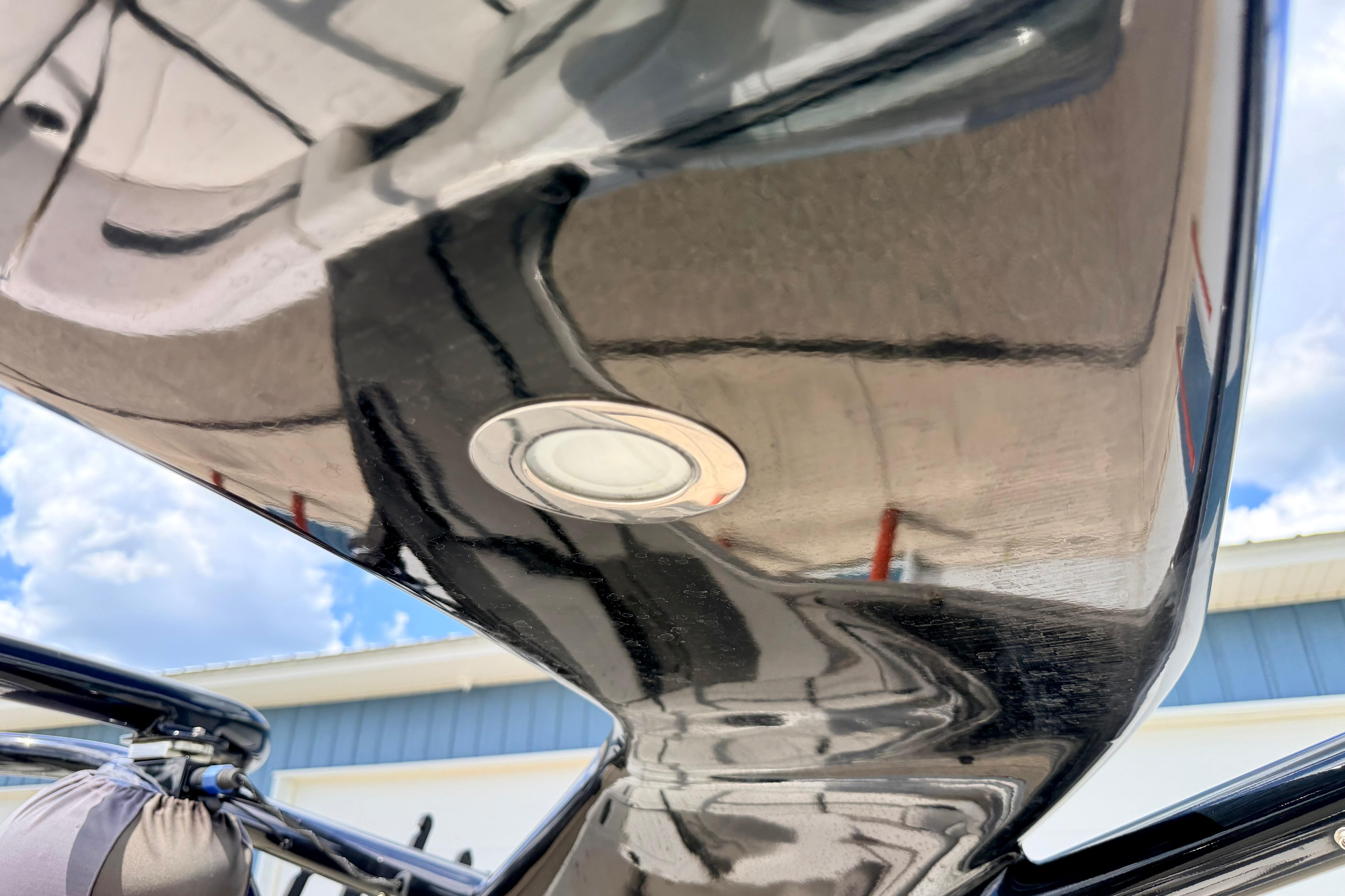 Close-up of a 2015 Chaparral Sunesta 264 boat hull with sleek, reflective finish.