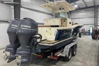 2005 Ocean Scout 255 boat with dual Yamaha engines in a storage facility.