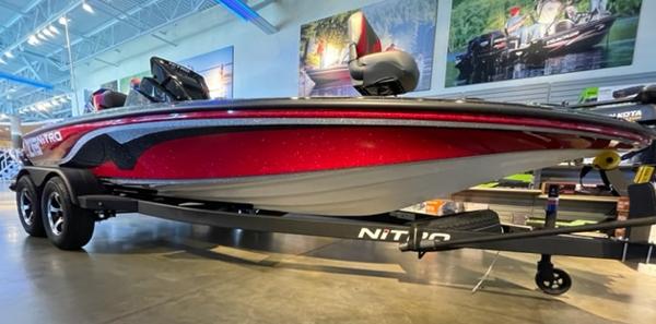 2025 Nitro Z19 boat in showroom, red and black design, on trailer.