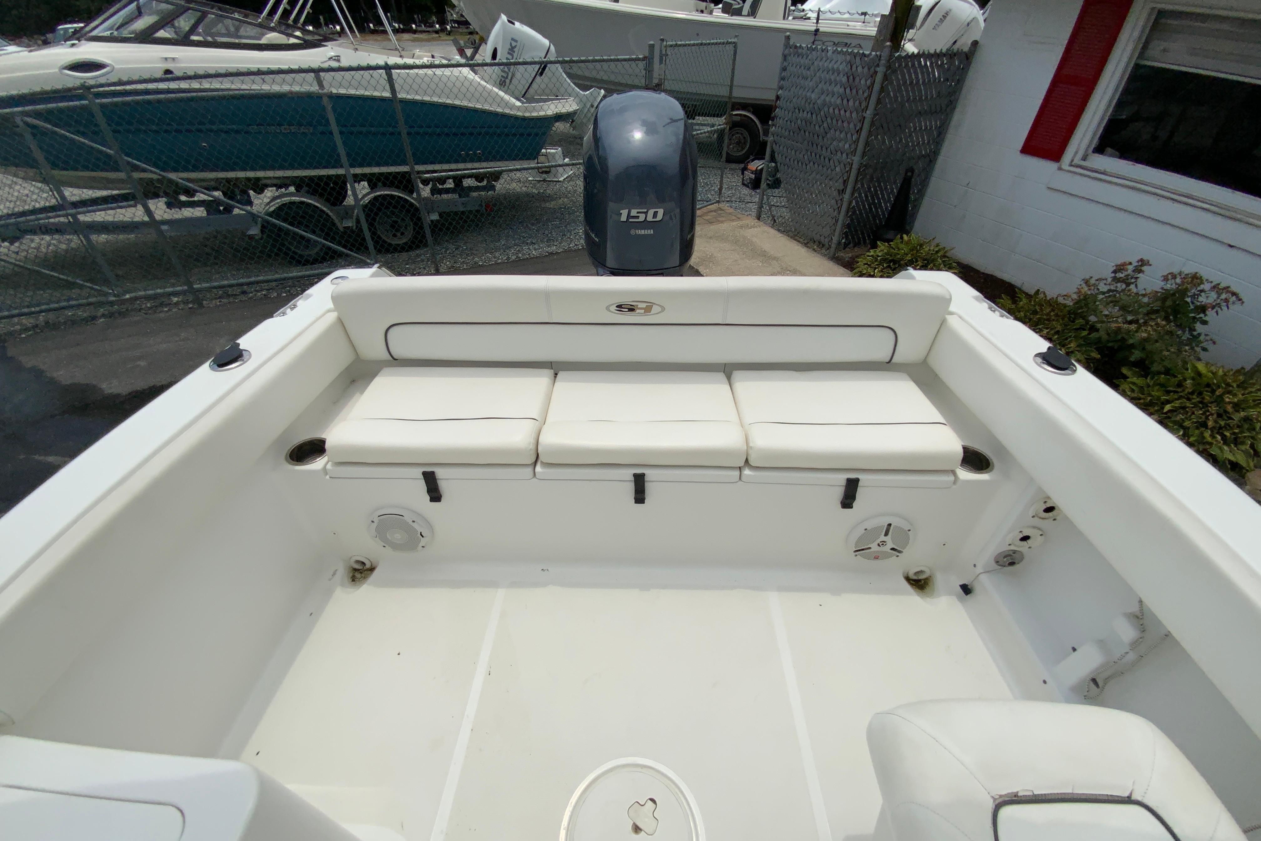2014 Sea Hunt Escape 211 LE boat interior with seating and motor view.